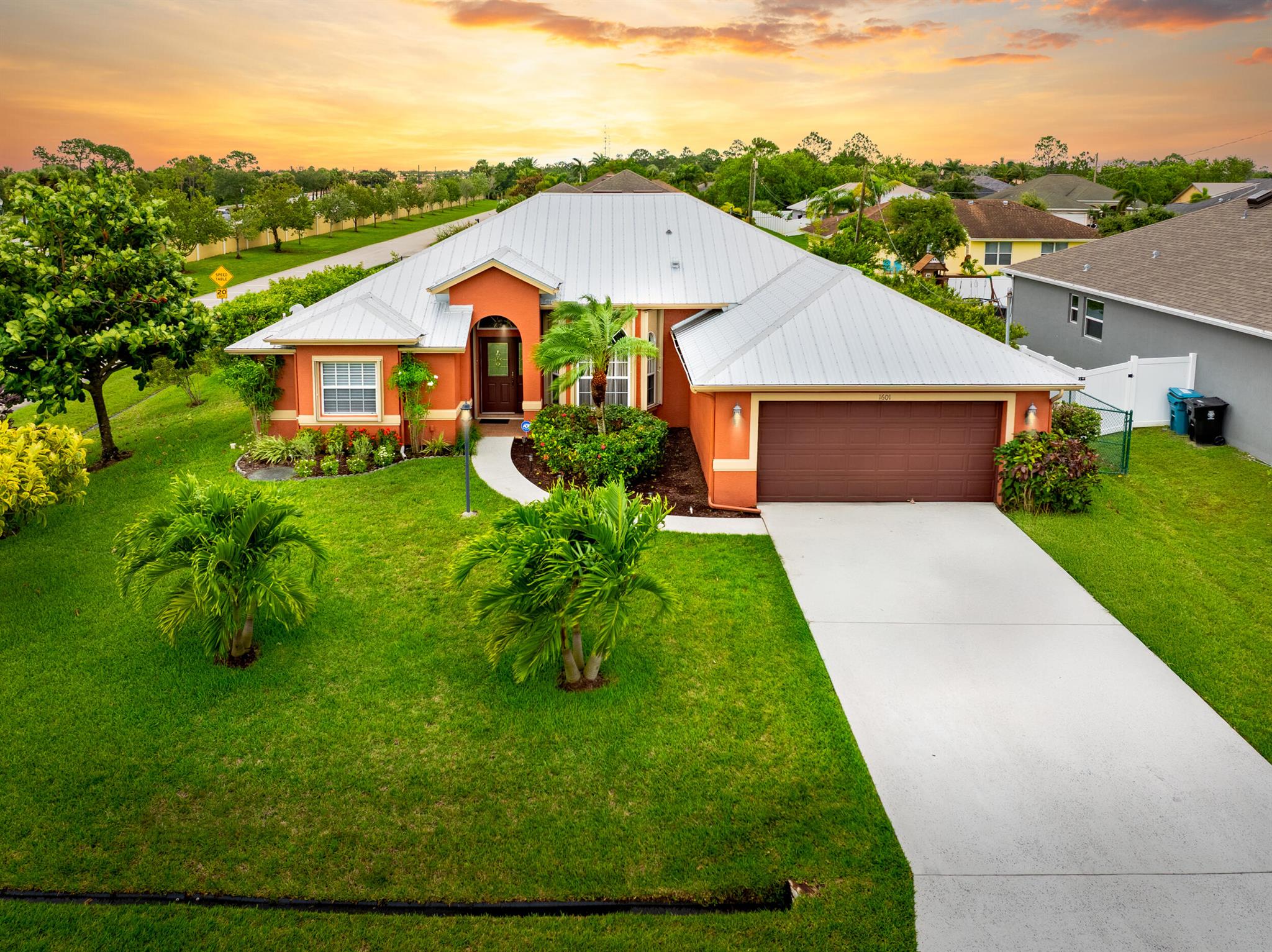 Don't miss this stunning 3-bedroom + den, 2-bath pool home on an over-sized corner lot! This beauty features vaulted ceilings, an upgraded kitchen with granite countertops and st.steel appliances, plus updated bathrooms! The spacious formal layout includes a large laundry room with an over-sized pantry, separate formal living and dining area, and a cabana bath that opens to a huge screened in sparkling pool. A pass-through window/convenient serving area is perfect for outdoor entertaining. The bonus Den is perfect for a home office or can be transformed into a 4th bedroom with ease. Enjoy total privacy in the backyard retreat with lush tropical landscaping and a fully fenced yard. Prime location just west of I-95, close to Tradition and St. Lucie West shopping and dining. 2019 Metal Roof!