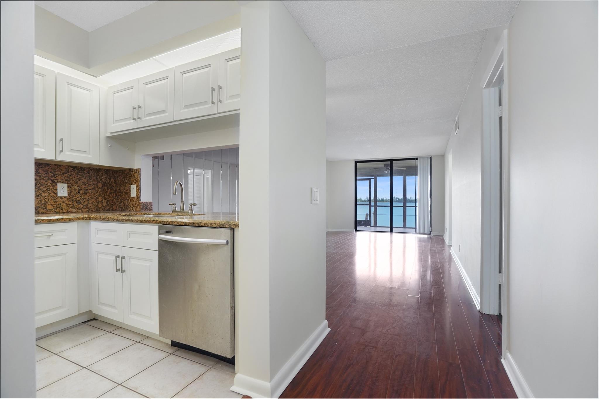 Best location in all of Lake Emerald! Ground floor, corner unit with no neighboring building, featuring gorgeous laminate floors in living and dining room, tile floors in the bedrooms, screened-in patio opening to the lakefront, and walking path. The parking space is directly in front of the unit. Closest to the community center, pool, and spa. Gated community with 24-hour security, 3 heated pools and spas, tennis courts, tiki huts bar, and much more. The association is requiring min 650 credit score.