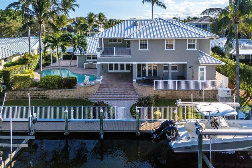 Experience luxury waterfront living in one of the best locations in North Palm Beach! The availability of these properties are limited to only a selected few streets which make them highly sought after as they offer deep water ocean access with no fix bridges.  This exquisite home is situated on a prime, over a quarter acre lot with 96' of frontage with two (2) boat lifts (24,000 and 12,000 lbs.) and can easily accommodate a boat or a few jet skis.  Removal of the lifts could accommodate a yacht up to 70 feet. The composite dock measures 5 x 70 with a fish table which was replaced in 2022, along with updated marine electric and custom lighting, all located on the serene Intracoastal. This home has been offers a NEW METAL ROOF and A NEW DORMER which