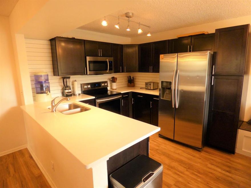 WOW! This stunning 2/2 ground floor condo is amazing! You'll love the way the gorgeous eat-in kitchen with banquette opens to the dining and living room. Everything is updated and beautiful and the rooms are spacious. Stainless appliances and Quartz counters in the kitchen. There's even a nice yard area just off your back porch. No age restrictions here! This is a wonderful community with pool, jacuzzi, clubhouse and it's location is convenient to the turnpike, shopping, golf restaurants, etc.  Tough to find a better place to live at this price!