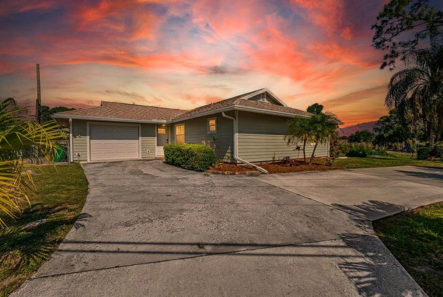 Welcome to this beautifully maintained canal point home in Port Saint Lucie, located on a desirable corner lot. This 2 bedroom, 2 bathroom residence offers peace of mind with a 2023 roof, impact windows, and sliding glass doors.  Enjoy serene lake views from the screened patio and lush backyard, which backs up to a walking path with exercise stations, creating a peaceful outdoor setting. A charming pergola garden adds to the home's inviting curb appeal.  Inside, the open layout features vaulted ceilings, tile flooring throughout, and a bright kitchen with granite countertops, wood cabinetry, skylight, and breakfast bar. The primary suite offers two closets and an updated ensuite with a floor to ceiling tiled shower, while the second bedroom and full bath provide comfortable accommodations.