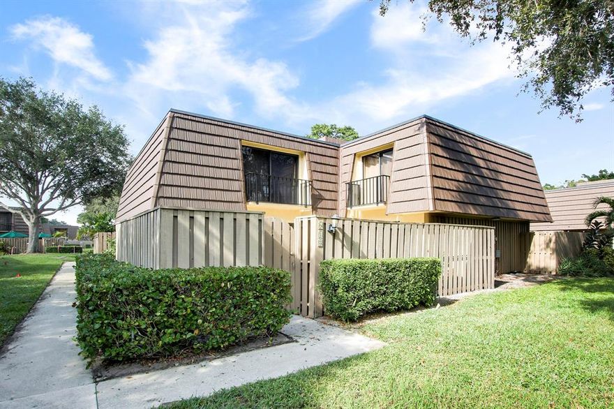 Come see this charming 2 bedroom, 2.5 bath townhouse in SUNNY Palm Beach Gardens! NEW METAL ROOF installed in 2021 (mansard & flat roof), A/C replaced in 2021, and water heater replaced in 2022. Kitchen features high-end wood cabinetry and granite countertops. The fully-fenced outdoor courtyard is perfect for enjoying the South Florida weather. The private eastern location of this townhouse provides an abundance of natural light with a relaxing water view.  Sandalwood Estates is a centrally located low HOA, pet friendly community - close to beautiful beaches (Juno & Jupiter beaches), transportation, world-class golf courses, incredible restaurants and only 15 minutes from Palm Beach International Airport!