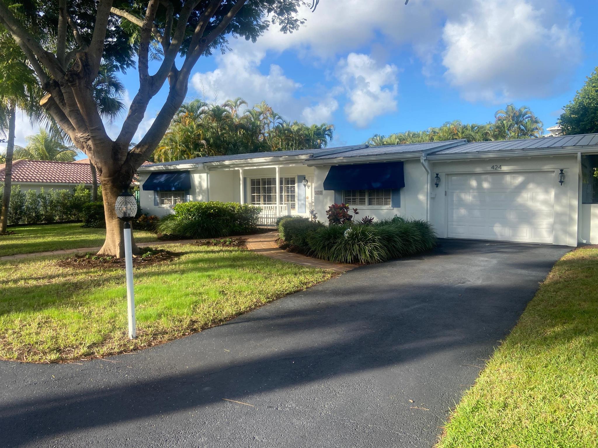 Nestled within the sought-after Palm Trail neighborhood in East Delray, this exceptional 3/3 property presents a rare opportunity for those seeking the perfect combination of location, space, and charm! Boasting a generous double lot, this meticulously maintained home is ready to welcome you! With a well thought out floor plan, this residence provides ample room for comfortable living and entertaining. Upon entry, the living room and dining room feature wood plank ceilings and terrazzo floors, providing that Old Florida feel. The spacious family room located in the rear of the residence has tons of windows showcasing premium views of the backyard, patio, and pool. The expansive backyard features an oversized pool, summer kitchen and abundant landscaping, ensuring the utmost privacy.