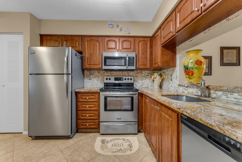 Photo of 7340 AMBERLY Lane #210, Delray Beach, FL 33446 (MLS # B26091665)