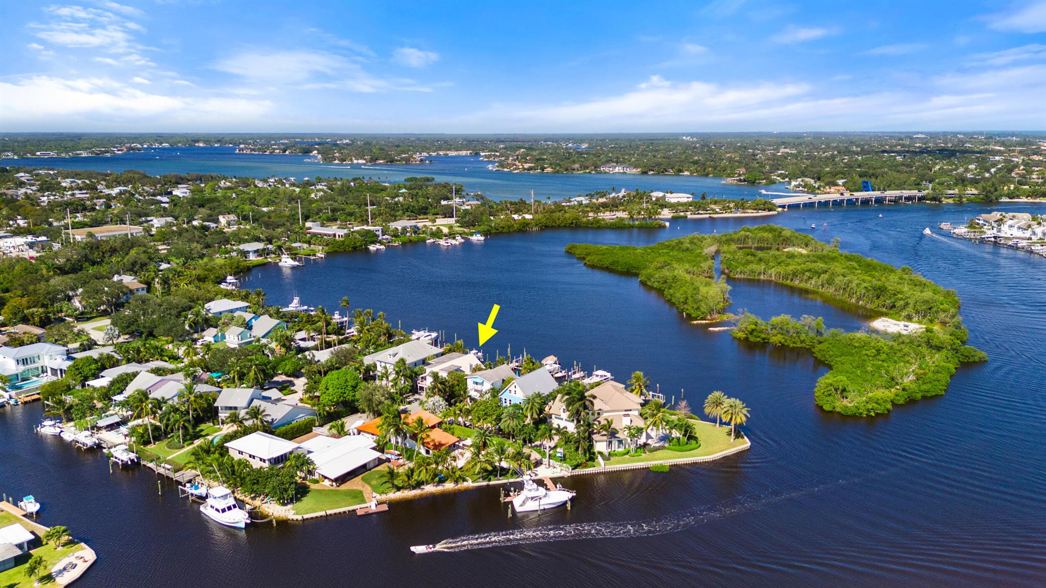 This stunning waterfront home, overlooks the serene waters of Sawfish Island. It is located just minutes from the Jupiter Inlet and with no fixed bridges, this three-story, four-bedroom plus den, three-bathroom residence with 3,516 Sq Ft living space, has been fully remodeled in 2022. The home's expansive open floor plan, with wide plank wood flooring throughout main living areas, is flooded with natural light and provides nearly unobstructed water views from almost every room. The open kitchen boasts quartz countertops, and high-end appliances including a 2022 oven, refrigerator, washer, and dryer, as well as a 2023 dishwasher, 2025 gas cooktop making it ideal for both daily living and entertaining. Recent upgrades also include two new air conditioning units installed in 2023,