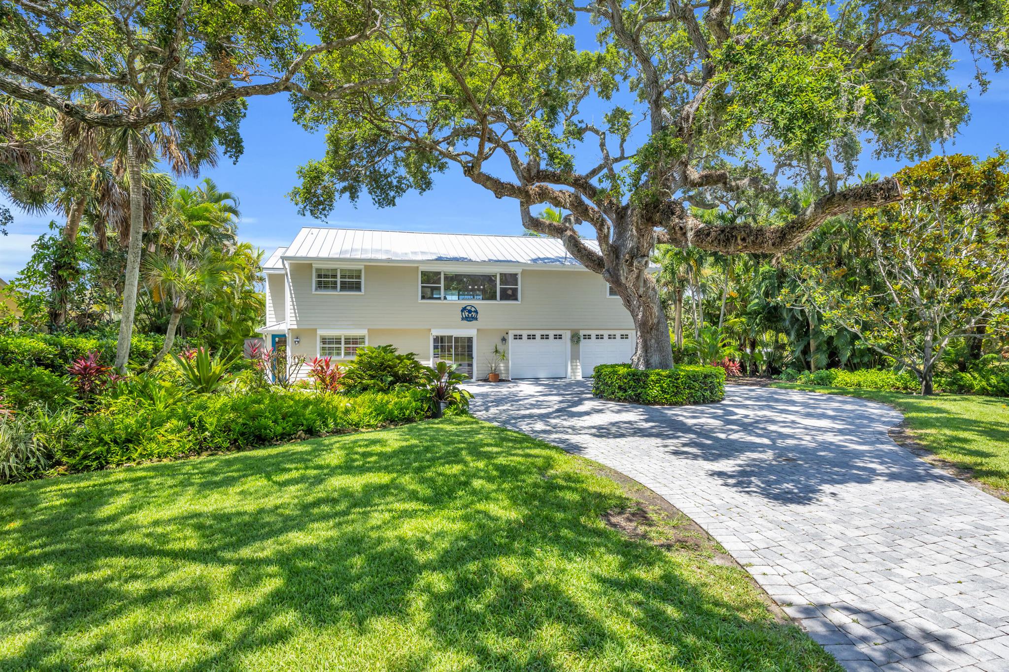 Wake up to daily dolphin & manatee sightings from your backyard at this unique riverfront home, complete with a private dock, 12,000-lb boat lift, and newly refinished seawall! Solid concrete block construction on both levels with coastal finishes, wood and travertine floors & easy roll-down hurricane shutters. Immaculately maintained with an air-conditioned garage, rebuilt well pump, new electrical panels, updated irrigation, and stunning landscaping enhanced by fruit trees and new lighting. Private, peaceful, and just steps from the ELC--perfect for boaters and nature lovers alike! Rmszapprox