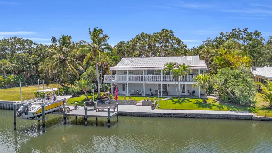 Wake up to daily dolphin & manatee sightings from your backyard at this unique riverfront home, complete with a private dock, 12,000-lb boat lift, and newly refinished seawall! Solid concrete block construction on both levels with coastal finishes, wood and travertine floors & easy roll-down hurricane shutters. Immaculately maintained with an air-conditioned garage, rebuilt well pump, new electrical panels, updated irrigation, and stunning landscaping enhanced by fruit trees and new lighting. Private, peaceful, and just steps from the ELC—perfect for boaters and nature lovers alike! Rmszapprox