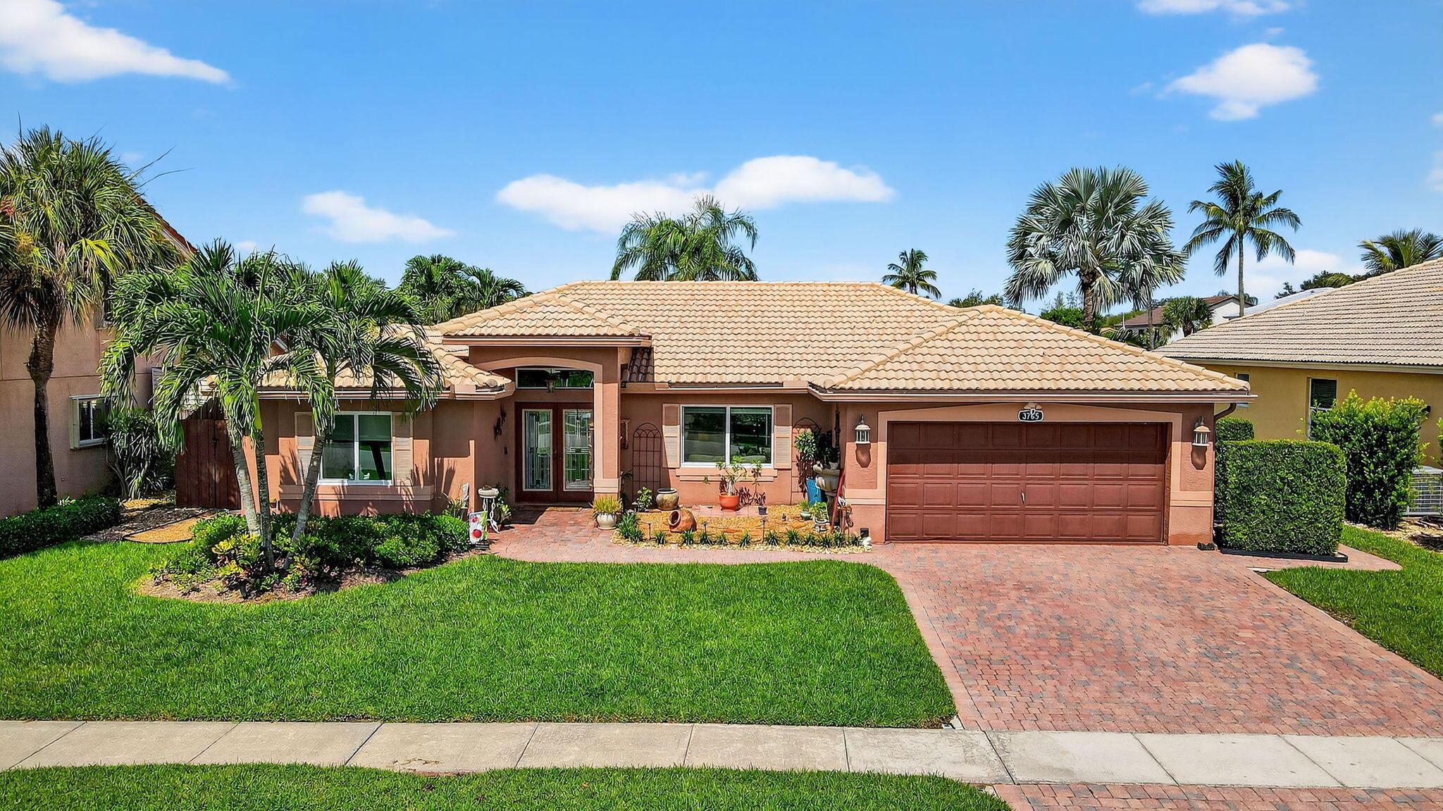 Welcome to this beautiful 3 bedroom, 2 bathroom pool home that combines luxury and comfort. The impressive vaulted ceilings create an airy atmosphere, while the split bedroom layout ensures privacy for family and guests. The kitchen features elegant wood cabinetry, quartz countertops, and stainless steel appliances, enhanced by ambient accent lighting. The dining room and family room boasts sliding glass doors that open to the resort-style pool area, offering a seamless indoor-outdoor experience. The primary suite serves as a serene retreat, with pool and lake views, a coffered ceiling, walk-in closet and a single closet. The luxurious primary bathroom includes dual sinks and a large walk-in shower. Hurricane ready with impact windows. Relax pool pool side or under the covered patio.