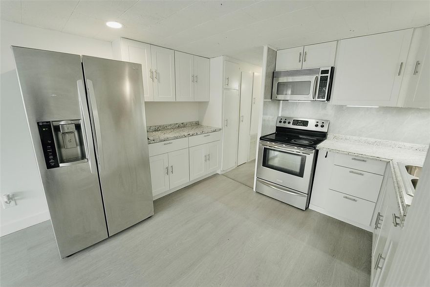 You own the land! Fully renovated. Absolutely gorgeous 3/2 with tons of potential to be a 5 bedroom. Modern renovation. Fully fenced for privacy. Carport - Shed - Lots of parking - Could possibly fit 5 cars - -3 separate driveways - -split bedroom plan - -Beautiful flooring through out - -Walls have drywall with extra insulation - -Newer water heater of 50 gallons - -Has both central air AC/heating mini splits - Association states it is HOPA verified - Great curb appeal - -Low maintenance fee of only $125 month - -Great investment - -Truly a must see.  Wont last!!!