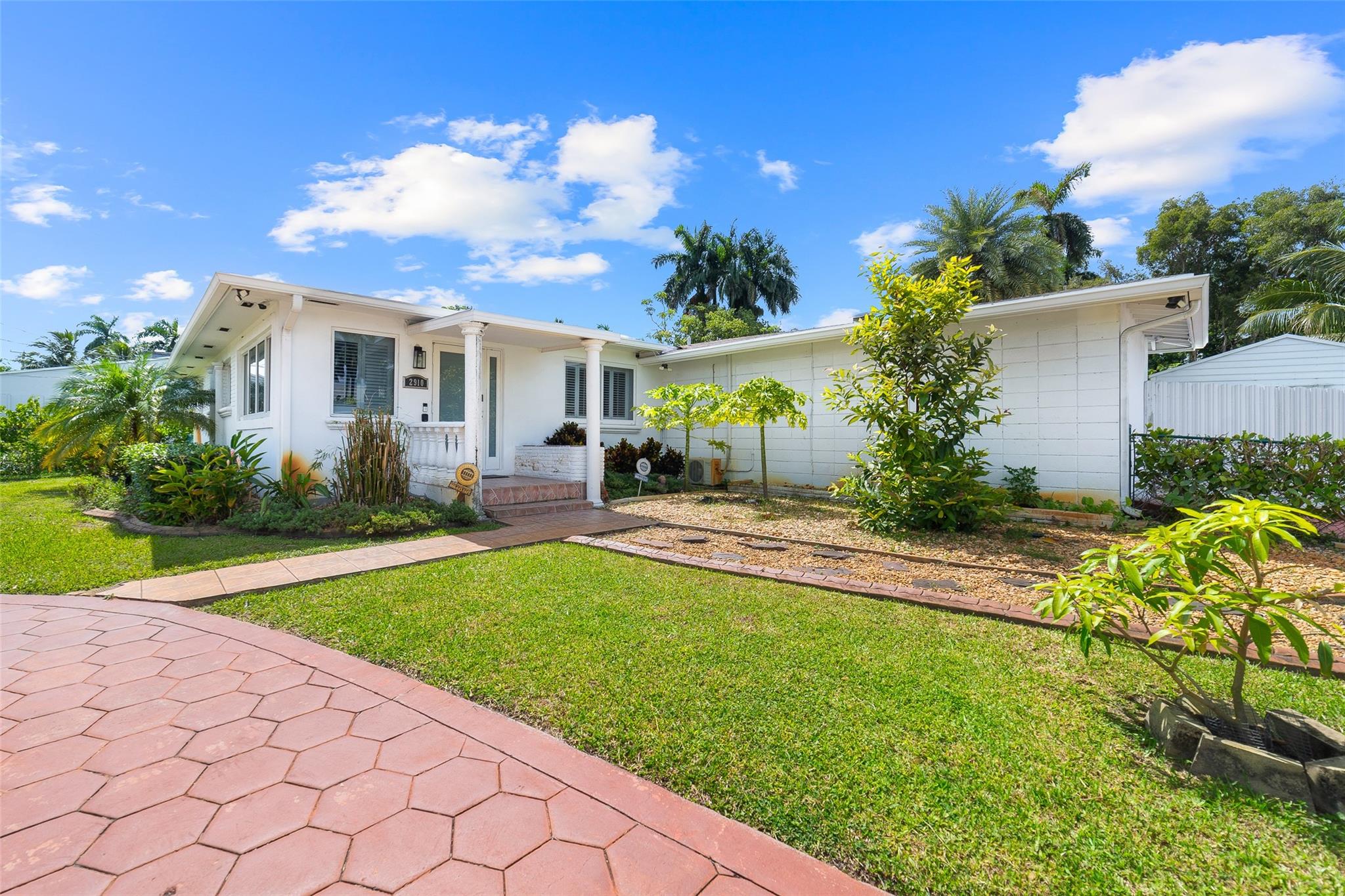 Beautifully renovated 4-bed, 3-bath home in Hollywood Little Ranches offers an open floor plan and 1,867 sq. ft. of comfortable living space. The kitchen features KitchenAid appliances, granite natural stone, and natural gas cooking. Enjoy terrazzo floors, plantation shutters, and a bright great room. Outdoor living shines with a pool, covered kitchen under a secure tiki hut, and serene water views. Situated on a huge lot with multiple access points, the property includes 23 mango varieties plus guava, avocado, star fruit, logan, june plum, cherry moia, jambote, and soursop. AC is 3 years old, and all renovations are fully permitted. Come see this one-of-a-kind retreat where every detail, inside and out, is designed to enjoy and share.