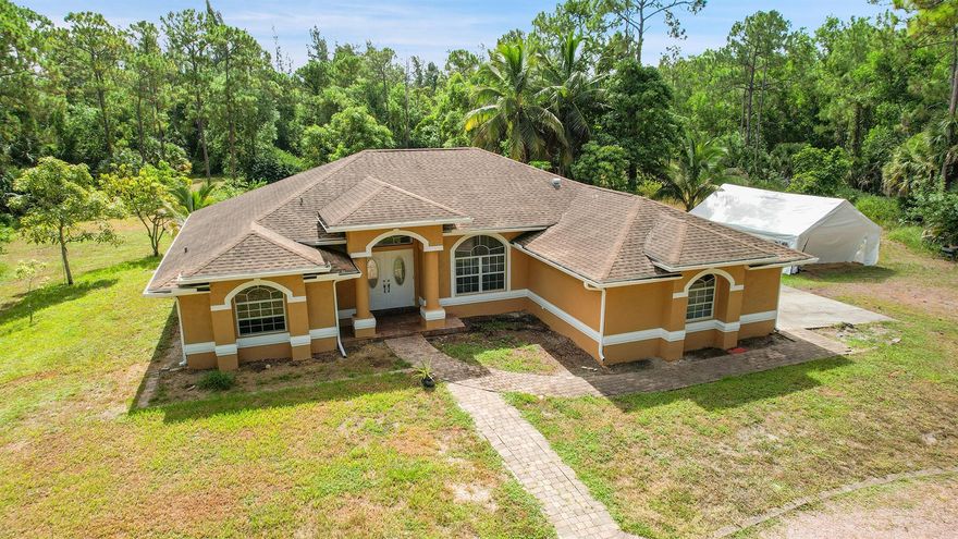 Spacious 3/2/2 CBS home on very private 5 acres in the beautiful equestrian community of Deer Run.Home is open, light and bright with vaulted ceilings and an open floor plan. The 5 acres has a dramatic palm tree-lined, long, circular driveway. The acreage is a blank slate for you to design and build out barns/paddocks/pool/etc. as needed.  There's even an existing ''pad'' for a guest house or barn. Or leave it as it is and enjoy the peace, tranquility and privacy of your own 5-acre slice of Florida paradise!Don't miss this lowest priced home in Deer Run!