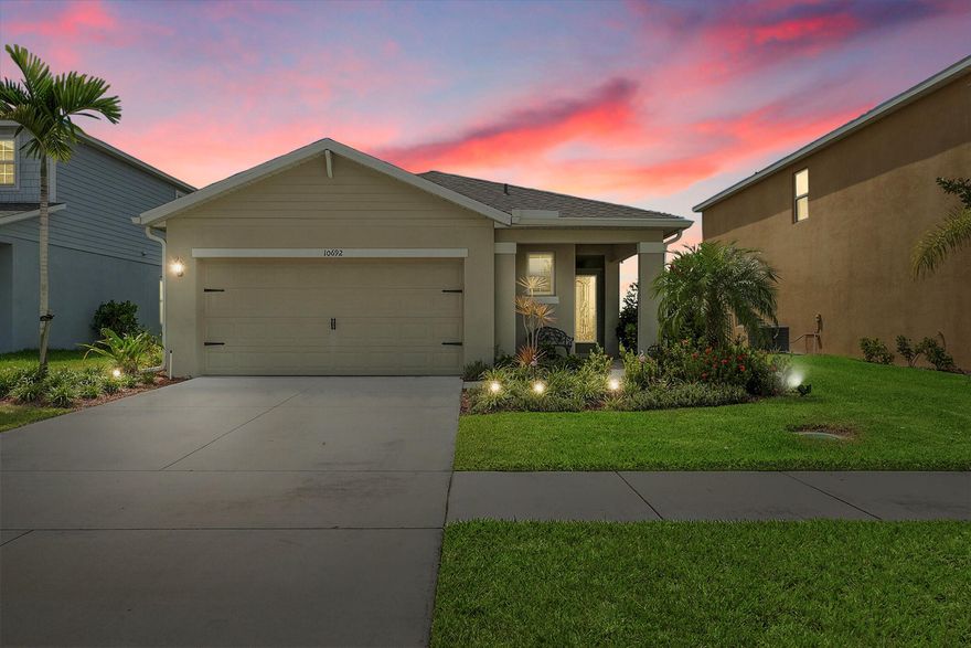 Beautifully maintained 3BR/2BA solar-powered home in Crosstown Commons with tranquil lake views and tile flooring throughout. The open-concept layout includes a modern kitchen with white cabinetry, stainless steel appliances, center island, and spacious living and dining areas. The primary suite features dual vanities, walk-in shower, and walk-in closet. Enjoy peaceful evenings from the screened patio overlooking the lake, can peacefully watch sunset. Community amenities include a pool, playground, and sidewalks. Low HOA. Conveniently located near I-95, Tradition, and St. Lucie West shopping and dining.