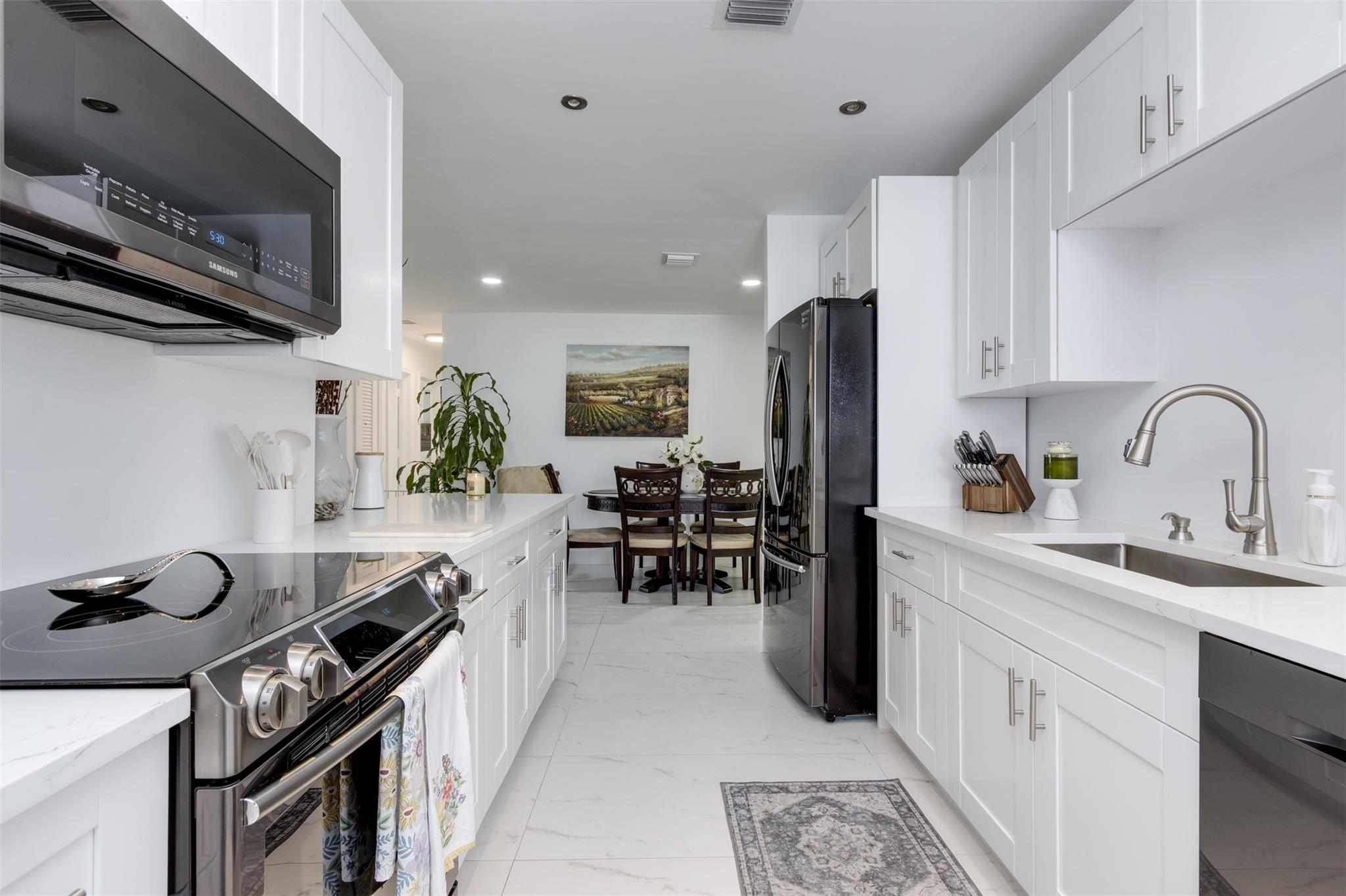 Welcome to this beautiful 3-bedroom, 2-bathroom Single Family home in Tamarac Lakes South. The gorgeous renovated kitchen, completed in 2025, features quartz countertops, black stainless steel appliances, and bright white cabinetry. This desirable floor plan with 2 full bathrooms and covered carport is a rare find in the community. Recent upgrades include a 2021 aluminum roof, 2023 AC, and tile flooring throughout. The private backyard has an awning for shaded outdoor enjoyment plus a variety of fruit trees. Low monthly HOA dues cover lawn care, sprinklers, community pool, clubhouse, golf, and exterior paint every 2 to 4 years, most recently in 2024. Pets are welcome, up to 3 per household. Located in a quiet, established neighborhood near parks & major roads.