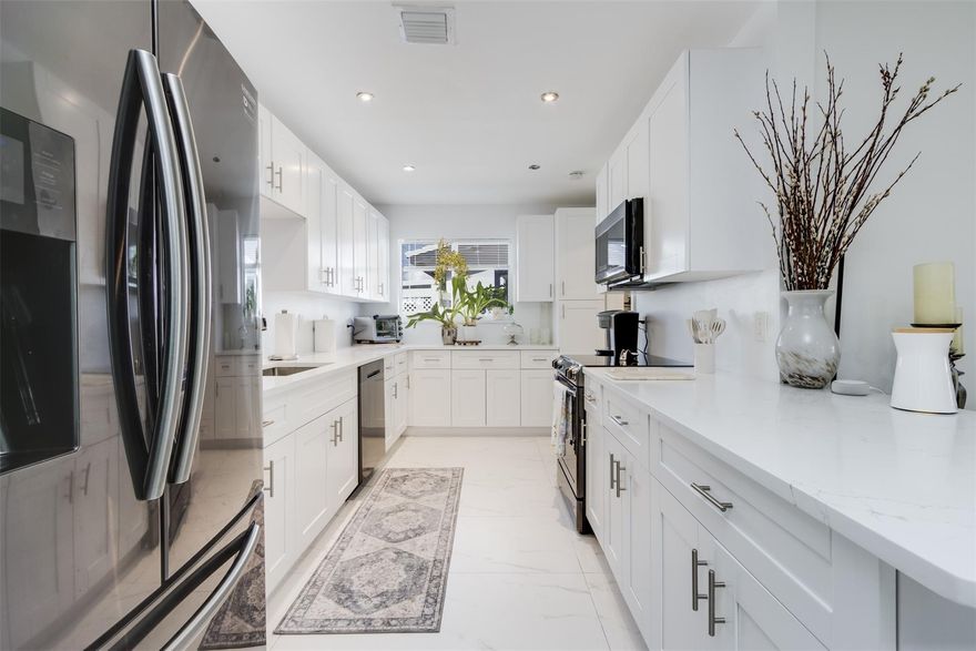 Welcome to this beautiful 3-bedroom, 2-bathroom Single Family home in Tamarac Lakes South. The gorgeous renovated kitchen, completed in 2025, features quartz countertops, black stainless steel appliances, and bright white cabinetry. This desirable floor plan with 2 full bathrooms and covered carport is a rare find in the community. Recent upgrades include a 2021 aluminum roof, 2023 AC, and tile flooring throughout. The private backyard has an awning for shaded outdoor enjoyment plus a variety of fruit trees. Low monthly HOA dues cover lawn care, sprinklers, community pool, clubhouse, golf, and exterior paint every 2 to 4 years, most recently in 2024.  Pets are welcome, up to 3 per household. Located in a quiet, established neighborhood near parks & major roads.