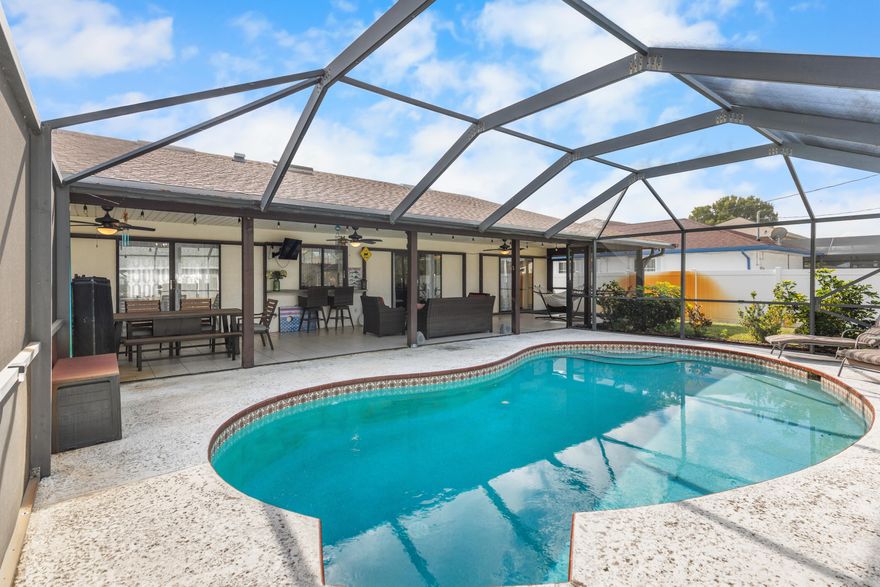 Step into this beautiful CBS (Concrete Block Stucco) Pool Home with NO HOA - park your RV, boat, or toys wherever you would like! Miss the rain while bringing in the groceries under the large covered front porch, and end the night relaxing under the oversized back patio watching the game or taking a dip in the screened in pool!   Meticulously cared for, the list of new features is endless: 2023 ROOF, 2024 new AC motor & fan, 2021 WH, 2022 freshly painted, 2022 new carpet, 2022 full kitchen refresh with new counters, sink, and cabinets, 2024 new pool screens, 2024 new washing machine, 2025 irrigation pump, 2025 pool pump, and more. Schedule your own private tour to see this spacious and functional home, perfect for entertaining and living!