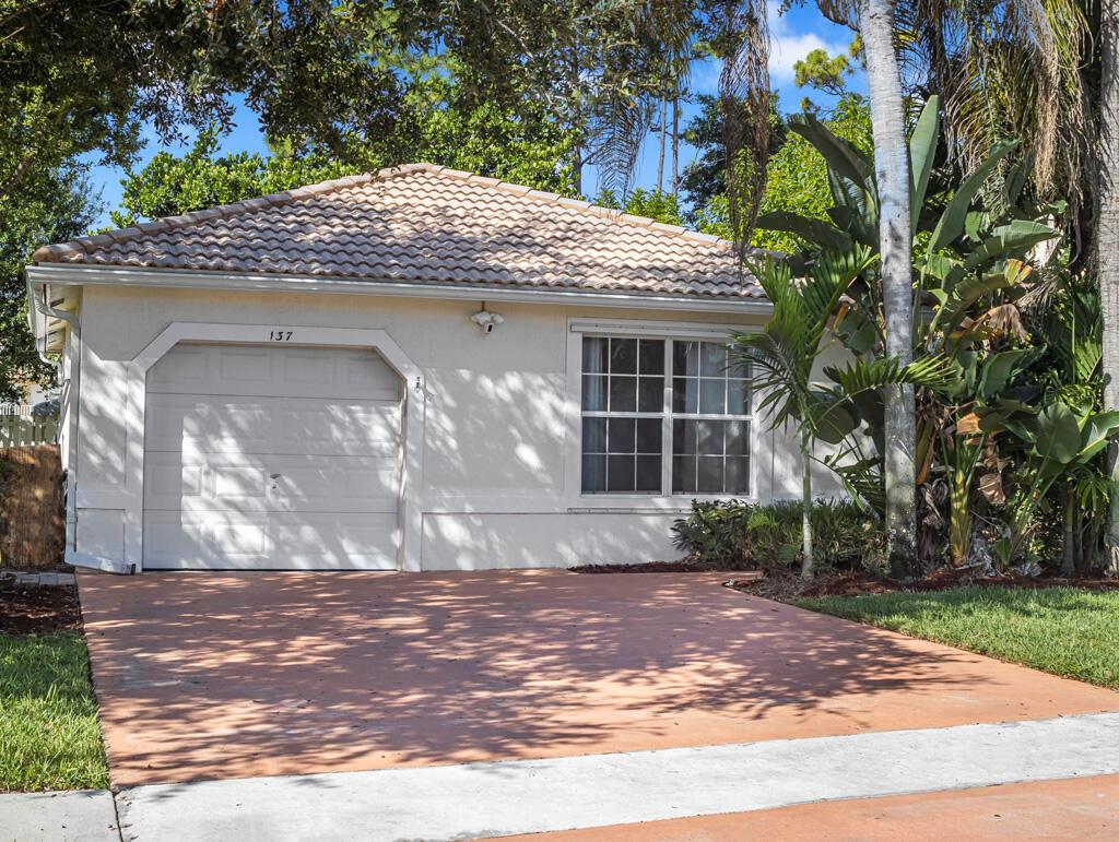 Welcome to this stylish 3-bed, 2-bath, 1-car garage home in the desirable, gated community of Country Club Views! This move-in ready gem features a split floor plan, 2 living areas, wood and laminate floors, 3 yr young A/C. The gourmet kitchen offers 42'' wood cabinets, granite countertops, stone backsplash, and Samsung stainless steel appliances including a French door refrigerator. The spacious primary suite includes dual walk-in closets and a double-vanity bath with a separate shower. Enjoy outdoor living in the fenced backyard with lush landscaping and brick patio. Low HOA fees include your lawn care, community pool, and playground. Conveniently located near top-rated schools, parks, shopping, dining, golf, and just a short drive to beautiful beaches.