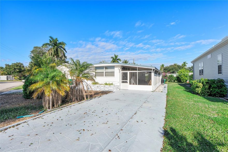 Fully furnished 3-bedroom, 2-bath home with a lovely screened patio and ample parking, conveniently located just steps from the clubhouse and pool. The split-bedroom layout includes a private entrance for added convenience. Additional features include updated windows, a newer main electrical panel, two storage sheds, and room for a patio in the back. Located in a very active community with 3 pools, golf, and numerous activities—and you own the land with very low monthly fees.