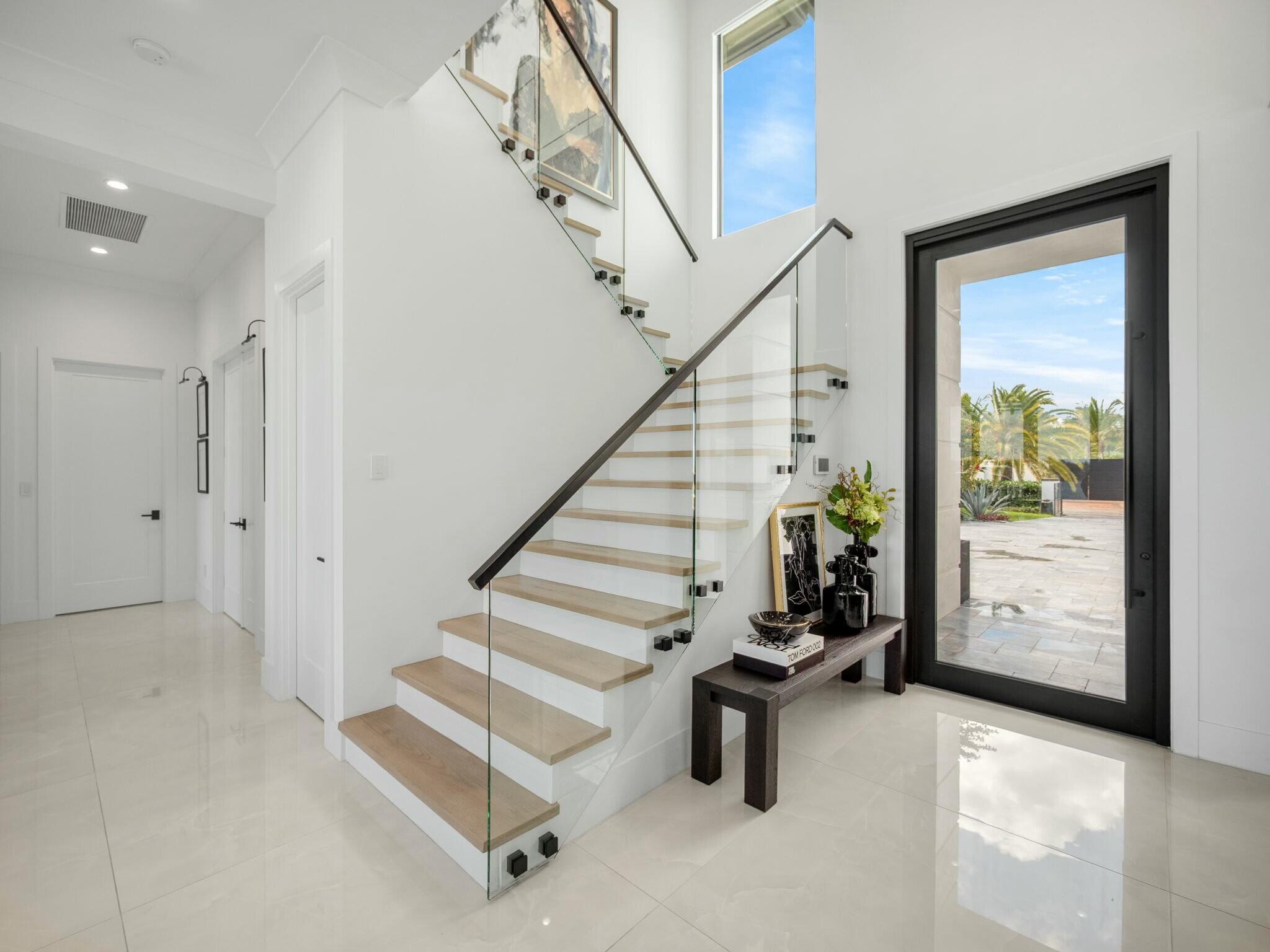 Priced to SELL. Tucked away at the end of a quiet cul-de-sac along the widest part of the Loxahatchee River, this newly built estate redefines luxury living in the heart of Jupiter. Step inside and experience expansive open concept living spaces enhanced by soaring ceilings, designer finishes, and walls of glass that frame breathtaking sunrise views over serene waterways. The main residence features 5 bedrooms all ensuite plus an exercise room and home theater. The guest house has 2 beds and 1 bath ensuring comfort and privacy for both family and guests. Perfect for extended family, visitors or staff accommodations. The home was thoughtfully designed for everyday living and entertaining. The gourmet chef's kitchen is a culinary dream, boasting dual islands, walk in butlers pantry,