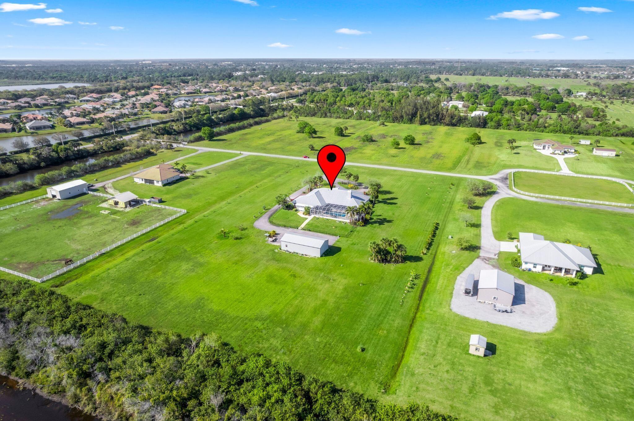 8135 White Fences Lane- Private Multi-generational Acreage Estate with Endless PossibilitiesWelcome to 8135 White Fences Lane, a serene and beautifully appointed estate located in one of Vero Beach's most desirable gated Equestrian communities. This expansive property offers almost 5,000 square feet and the perfect blend of space, privacy, and flexibility. With a total of 6 bedrooms and 5 bathrooms, including a separate 2-bedroom, 1-bath in-law suite complete with its own full kitchen and laundry. Ideal for multigenerational living, guests, or rental potential.The main residence features an airy, open floor plan with soaring ceilings, wood burning fireplace, abundant natural light, and elegant finishes throughout.