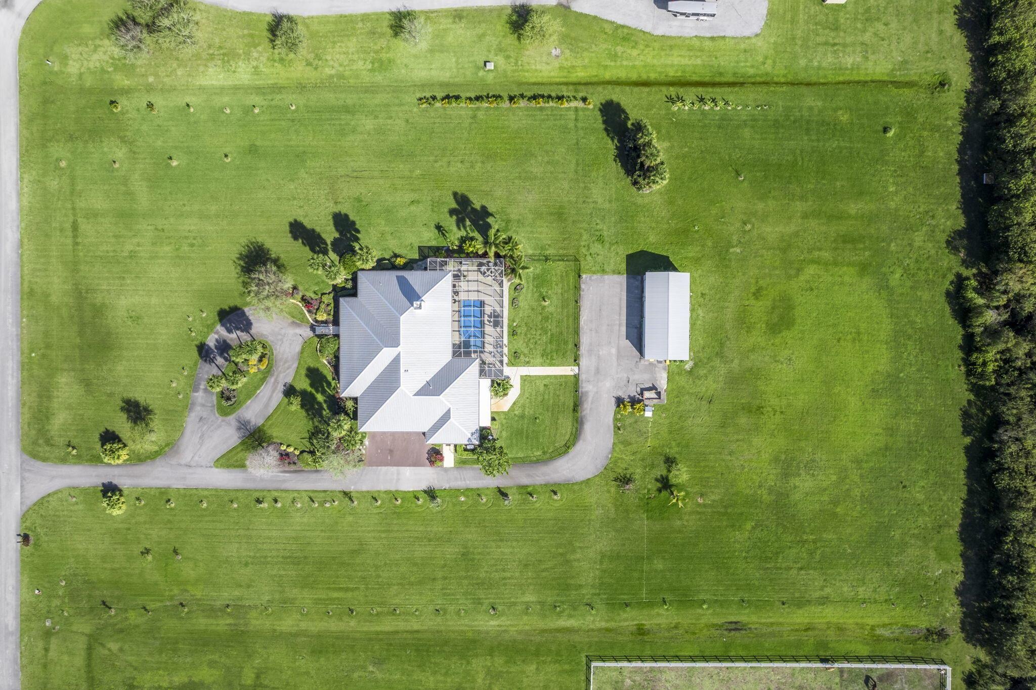 8135 White Fences Lane- Private Multi-generational Acreage Estate with Endless PossibilitiesWelcome to 8135 White Fences Lane, a serene and beautifully appointed estate located in one of Vero Beach's most desirable gated Equestrian communities. This expansive property offers almost 5,000 square feet and the perfect blend of space, privacy, and flexibility. With a total of 6 bedrooms and 5 bathrooms, including a separate 2-bedroom, 1-bath in-law suite complete with its own full kitchen and laundry. Ideal for multigenerational living, guests, or rental potential.The main residence features an airy, open floor plan with soaring ceilings, wood burning fireplace, abundant natural light, and elegant finishes throughout.
