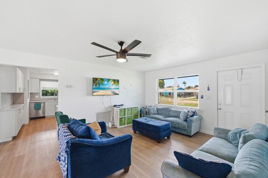 Beautifully updated 3BR/2BA CBS single-family home with NO HOA! This move-in-ready property features 1,281 sq ft, impact windows, new laminate flooring throughout (no carpet), and fresh interior/exterior paint. The remodeled kitchen offers a gas stove and newer appliances (under 5 years). Major upgrades include a 2-year-old roof, new plumbing, new water heater, and solar attic vent. Spacious primary suite with walk-in closet, plus large closets in guest rooms. Enjoy a screened-in patio, oversized backyard with fruit trees, and new PVC fencing—perfect for entertaining. Additional highlights include a laundry/utility room, attached carport, and large driveway. All renovations completed with permits.