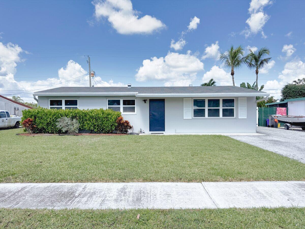 Charming 3 Bedroom, 2 Bath home Featuring a Newer 2021 Roof, Newer Electrical, Newer Windows, Freshly Painted Interior, Hurricane Impact Sliders, Spacious Yard with room for a Pool, Boat or RV, Screened Patio, New Gutters, White Vinyl Fence and a Large Storage Shed. A Generous Kitchen with newer Stainless Steel appliances and Granite Counters has plenty of cabinet storage. The Primary bedroom has an en-suite bath and a full laundry room attached. This home is located with easy access to I-95, PBI Airport, World Class Beaches, Shopping and Restaurants. No HOA restrictions.