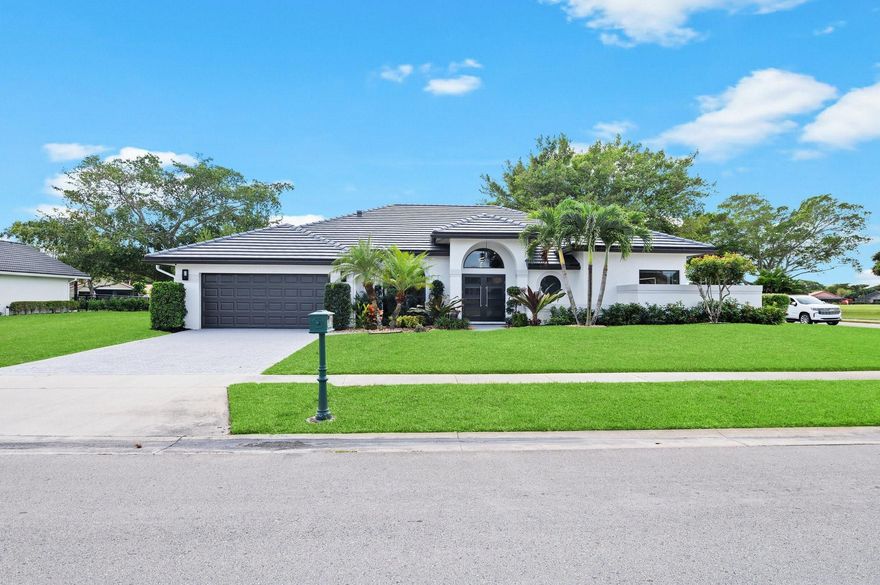 Spectacular GOLF COURSE & LAKE home located on a LARGE CORNER LOT with beautiful oak trees in prestigious Boca Woods Country Club. NEW FLAT TILE ROOF 2022, NEW IMPACT WINDOWS & DOORS 2022, WATER HEATER 2021. OPEN FLOOR PLAN, vaulted ceilings, recessed lighting & designer light fixtures. Gorgeous NEW KITCHEN with custom cabinetry, quartz counters, DOUBLE ISLANDS & COMPLETE LG Pro Appliances. NEW OVERSIZED PORCELAIN tile. Split bedroom plan UPDATED primary bath, all new closet systems thru-out. Silhouette window treatments & professionally decorated interior. Designer furniture sold separately. Fenced yard, NEW TRAVERTINE MARBLE PATIO, NEW POOL W/SUNDECK & HEATER. Golfers paradise, 3rd garage for your own golf cart. NEW 15 million dollar clubhouse renovation with 2 beautiful 18 hole courses!
