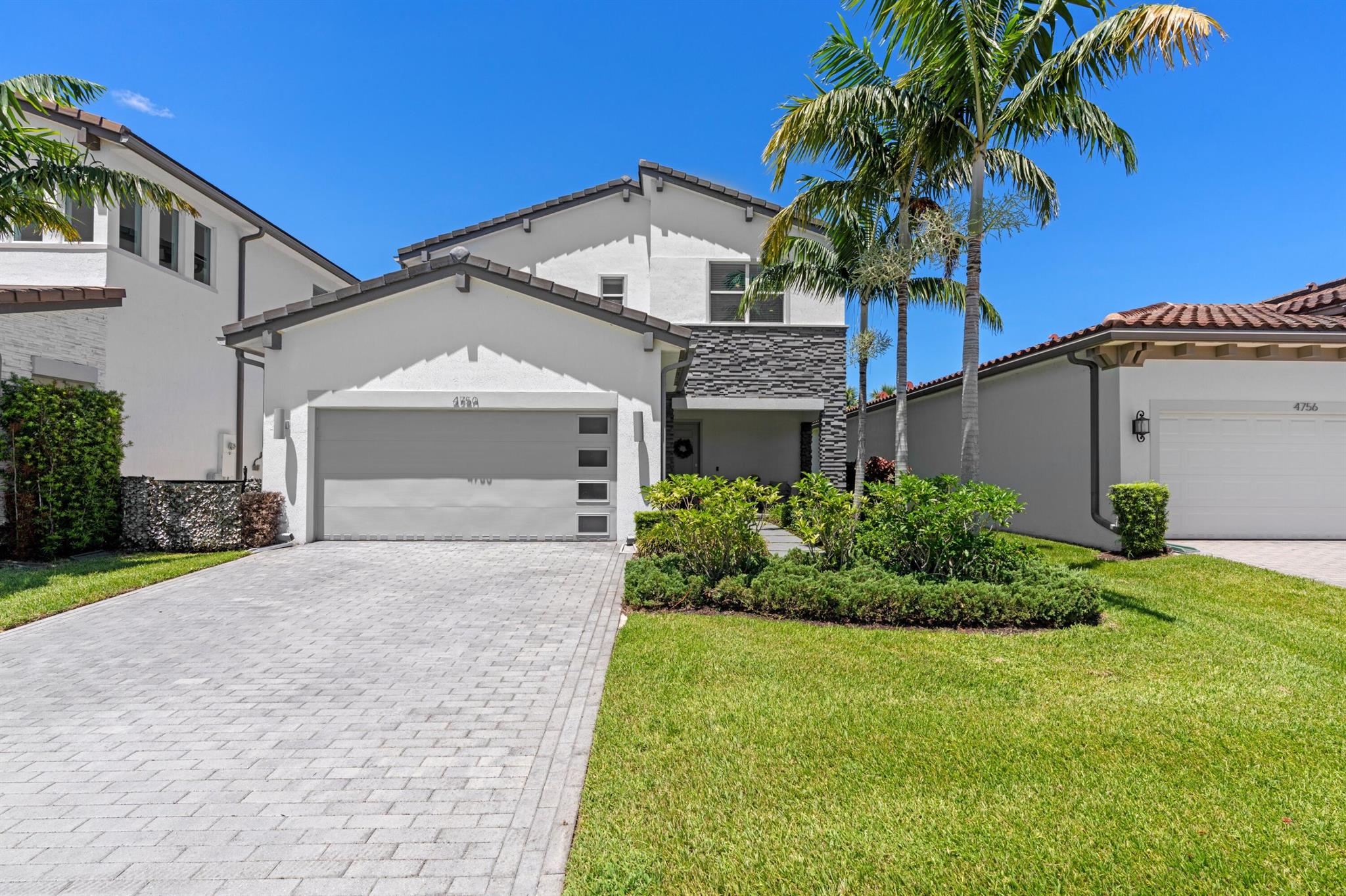 Built in 2019, this two-story home blends modern style with lasting quality, featuring full impact windows and doors. The centerpiece is a chef's kitchen with natural gas, premium finishes, and open flow for entertaining. A convenient downstairs bedroom with full bath offers flexibility for guests or multigenerational living. Upstairs, the renovated primary bathroom provides a spa-like retreat. With high ceilings, bright living spaces, and thoughtful upgrades, this home is move-in ready.Located just minutes from the Wellington Showgrounds, Lotis, and the mall. Andalucia features a resort style pool, fitness center, and lawn service for easy living.