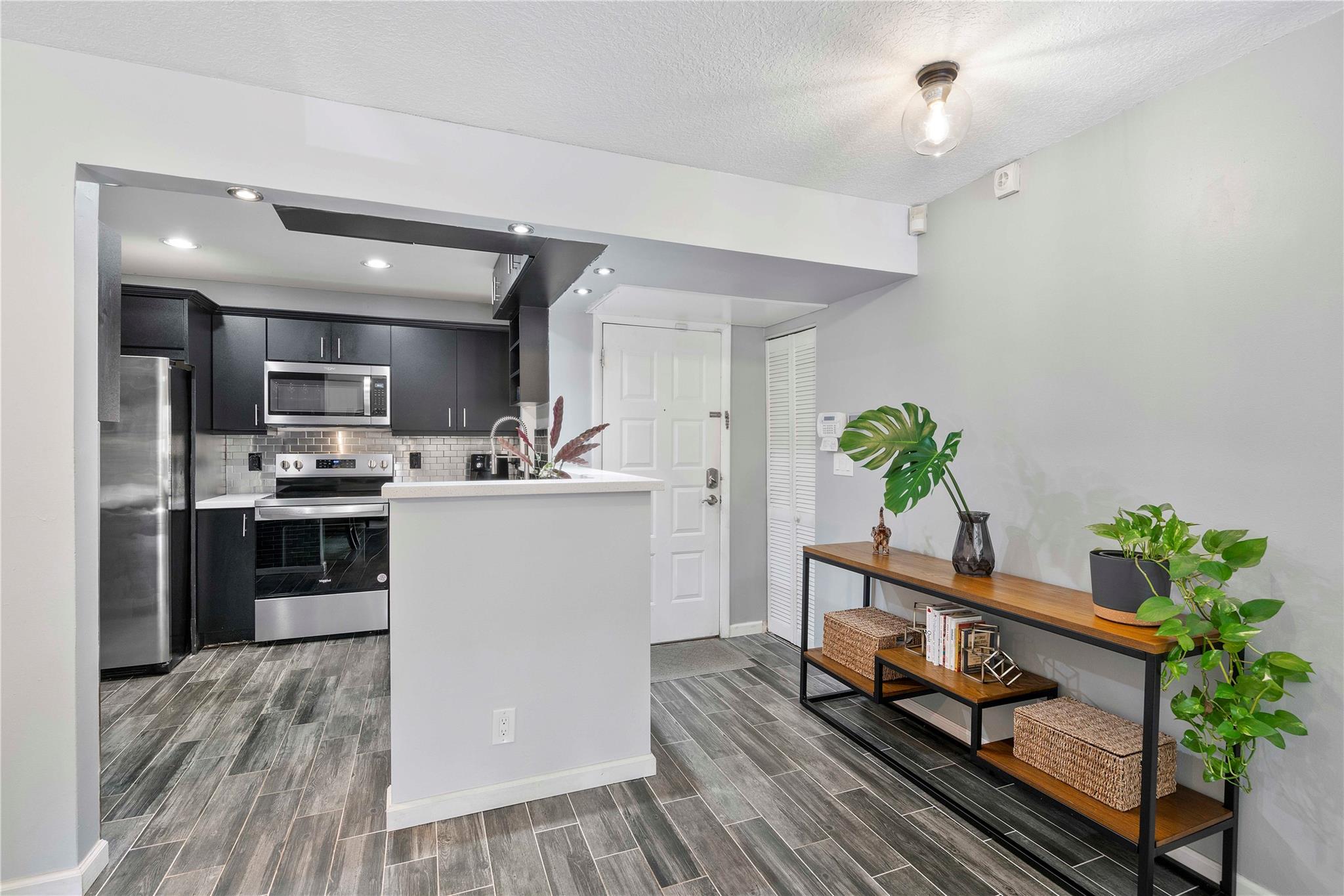 Bright & modern 3-bed, 2-bath condo in Coconut Creek’s desirable Township, part of the amenity-rich TCMA community. This spacious, updated home features an open layout with abundant natural light, newer A/C & stylish finishes. The remodeled kitchen boasts granite counters, stainless steel appliances & custom cabinets that flow into the dining and living areas—perfect for entertaining. Enjoy the enclosed Florida room year-round as a sunroom, office, or hobby space. The primary suite offers a walk-in closet and en-suite bath w/walk in shower & double vanity. Two more bedrooms, an updated second bath, in-unit laundry, ample storage & assigned parking plus guest parking complete the home. Enjoy resort-style amenities at TCMA including pools, fitness center, theater, tennis & more!