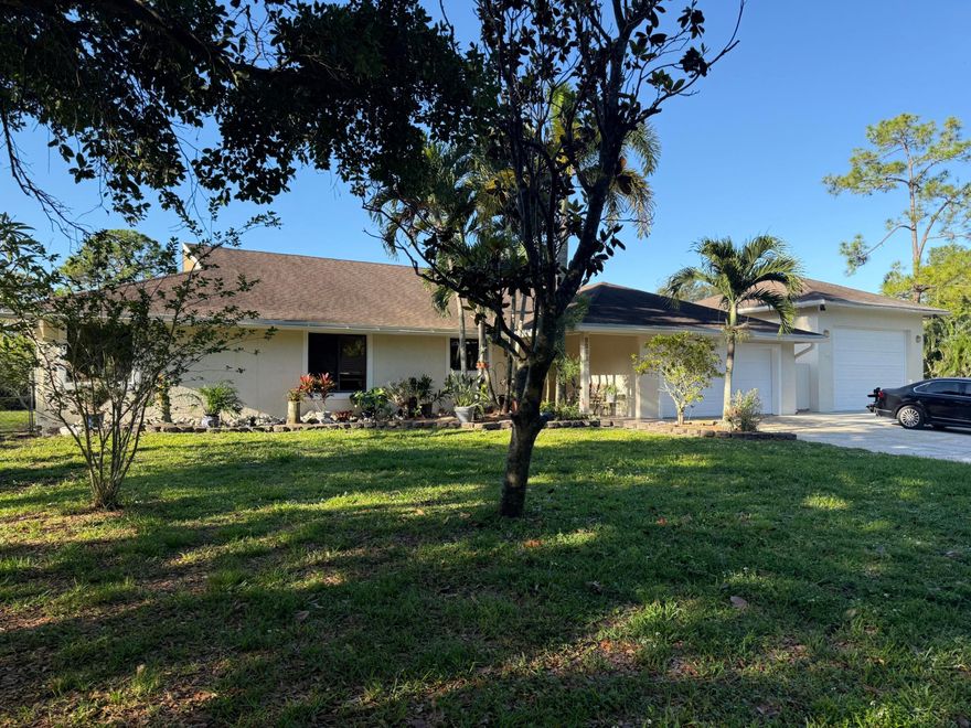 Fantastic opportunity to have one acre with no hoa with a great home with 4 bedrooms 2 bathrooms 2 car garage plus an additional garage/workshop with 10h x 15w overhead door. Lots of exotic plants and trees.  Close to everything including equestrian, restaurants, shopping and turnpike.