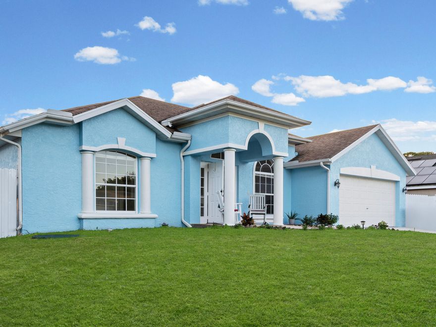 This move-in-ready single-family home blends comfort, privacy, and flexibility in a quiet Port St. Lucie neighborhood with no HOA restrictions. The soft powder-blue exterior creates eye-catching curb appeal, complemented by a neatly kept lawn and a fully fenced backyard.

Step outside and enjoy true Florida living. The backyard features a custom metal patio cover over a spacious paver patio, complete with lighting and a ceiling fan--perfect for relaxing evenings or hosting friends. There's also room to easily convert the space into a screened enclosure if desired.

Inside, the home feels light and welcoming with fresh interior paint throughout. The kitchen has been refreshed with newly painted cabinetry, and the primary bathroom offers a clean, comfortable retreat.