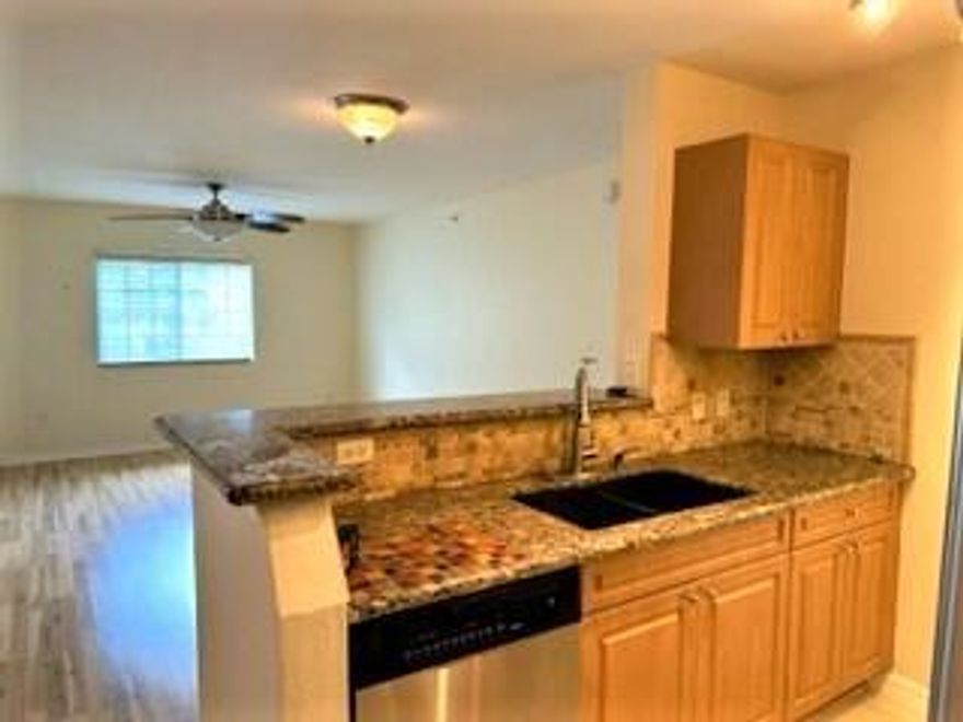 Enjoy all the amenities of the beautiful Green Cay Village in this 2nd Story Corner 2 bd/2 bath (Laurel Oak floorplan) Condo. Brand new A/C just installed! Unit features tropical views with extra windows, North facing view away from parking lot & conveniently located next to Elevator. Elegant touches incl Granite counter tops, tumble marble backsplash, newer energy efficient stainless steel appliances & stack front load w/d, ceiling fans, walk in closets, newer laminate flooring, alarm system & assigned parking at your front door. Low HOA includes water/cable, ext maint, Clubhouse: free wifi, TVs, kitchen, indoor kids play area, Large Pool & Tot pool w/fountain, playground, BBQ area, Fitness Cntr, & landscaped walking path. Great location close to shopping, beaches & entertainment! Recent Upgrades: 
July 2023 - New A/C installed
Nov 2022 - New Stack Front Load Washer & Dryer
April 2021 - Stainless Steel Smooth Top Self Clean, Convection & Air Fry: Range/Stove
Feb 2019 - New fridge with ice-maker   
March 2017 - Laminate Flooring installed in both bedrooms & living room.