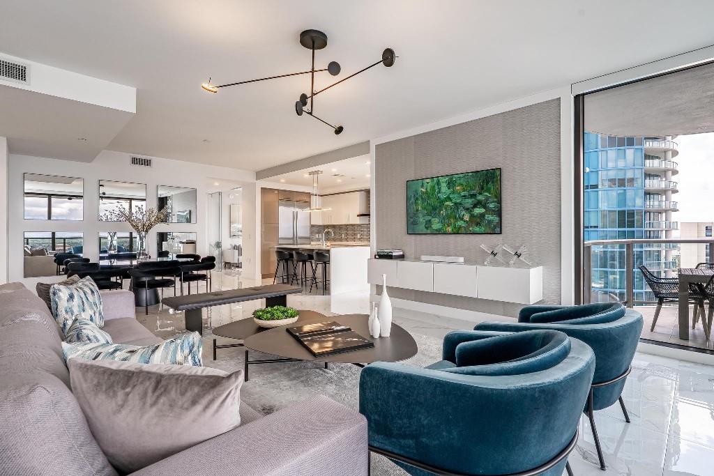 Stunning 30th-floor residence at 100 Las Olas! Experience luxury living at its finest at 100 East Las Olas! Unit 3004 showcases the building’s most sought-after floor plan, blending warm sophisticated design with premium upgrades. This spacious 2-bedroom+den/office (or optional 3rd bedroom), 3 full bath home features an open layout and 550 sq ft of outdoor terrace with breathtaking river and city views. Highlights include porcelain tile flooring, quartz countertops, motorized blinds, designer lighting, custom built-ins & closets, and two premium side-by-side parking spots (both Electric Vehicle ready). Enjoy five-star amenities and the vibrant energy of Las Olas. Furniture is available for separate purchase for a seamless move-in experience.