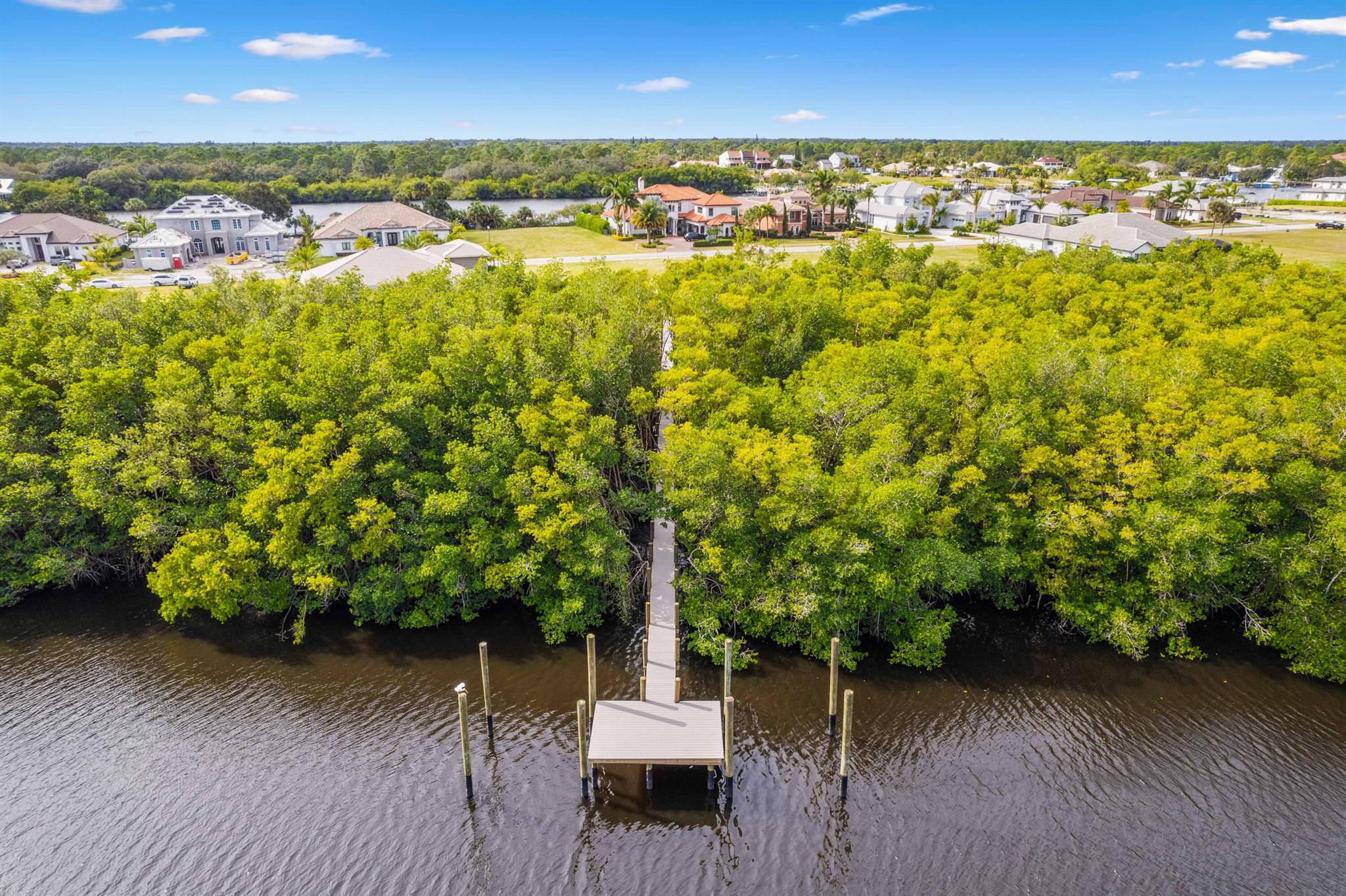 Exclusive Waterfront Construction! Vacant land of .34 acres with dock for sale. Embedded in the double gated private Island of Ravello community. Located on the St Lucie River, in the Treasure Coast known for its tranquil nature with full ocean access 25 minutes away, no bridges. ELEGANCE & LIFESTYLE! Trails, Kayaking, Tennis Courts, Pool & Clubhouse. Near Beaches, Restaurants & more! 2 boat slips with pilings wrapped with Perma Wrap,16k lift each plus lighting. Dock is surrounded by protected wetlands, a nature's sanctuary, uniqueness like no other. No wake zone. Boardwalk is 315' x 4' of AZEK Composite completed Oct 2024. Create a home with your own private oasis along a lavish tranquil canvas landscape. In addition, you may upgrade your dream home by combining adjacent property.
