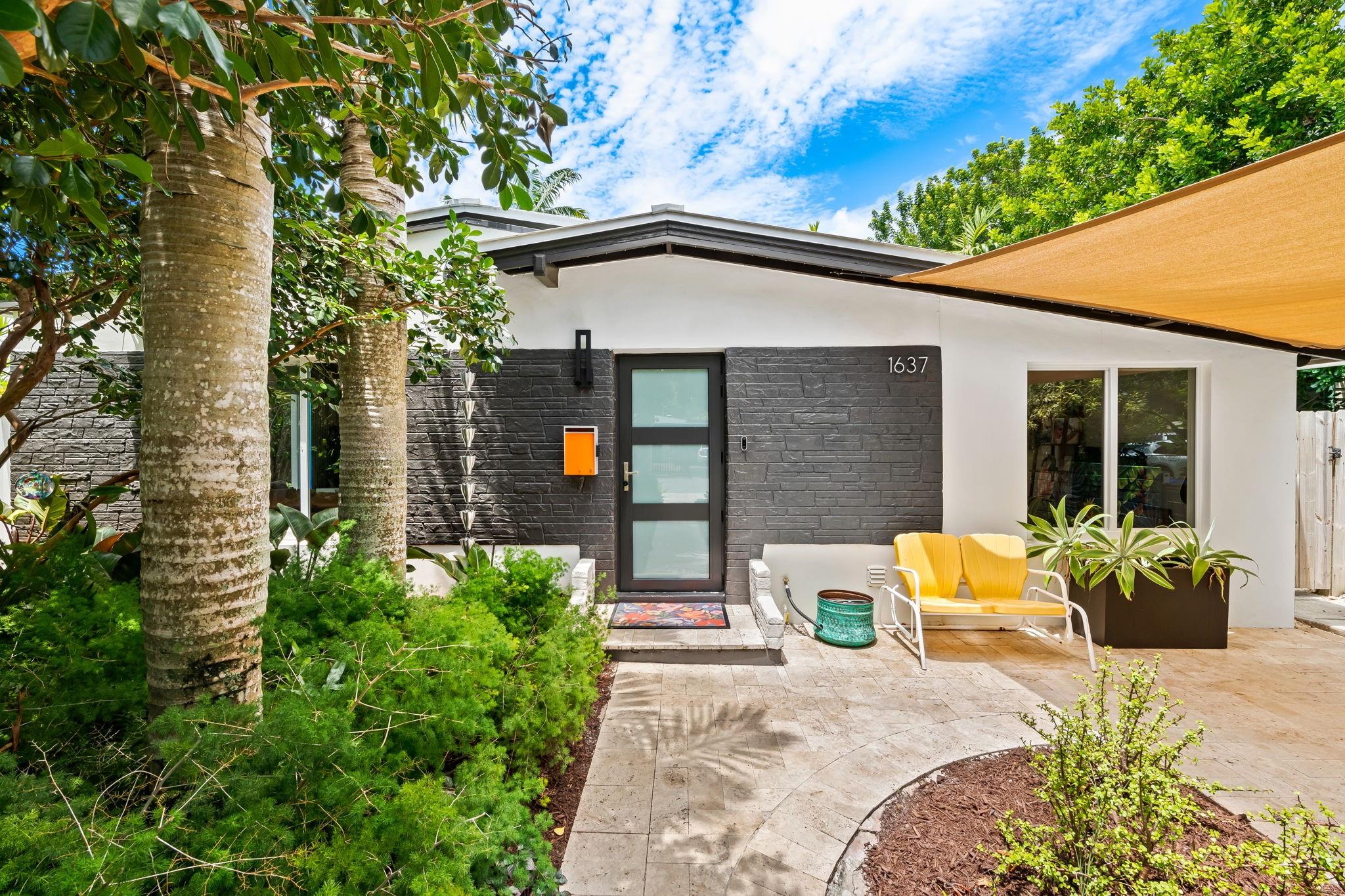 Thoughtfully curated modern retreat in the heart of Fort Lauderdale blends high design with relaxed S. Florida living. Inside, sleek wood-look tile floors, crisp white walls, and impact-rated windows flood the home with natural light. The open-concept kitchen is perfect for entertaining. The primary suite offers a walk-in closet, tranquil pool views, and direct pool access. Its spa-inspired ensuite includes a soaking tub, rain shower, and dual vanities. Outside, the backyard is a tropical paradise with a heated saltwater pool, metal-roofed pergola, and vibrant landscaping. The home is equipped with a premium metal roof, solar panels, and three A/C zones for efficient climate control. Located near Wilton Manors, downtown Fort Lauderdale, and the beach, this property blends style and comfort