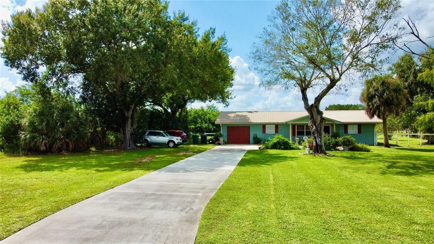 Welcome to your peaceful paradise! Set on a spacious 5.5 acre lot, this 3-bedroom, 2-bath home offers comfort, functionality, and country charm. Inside, enjoy an open layout with tile flooring throughout and a kitchen featuring stainless steel appliances. Relax on the large screened-in back porch, perfect for enjoying quiet views.
Additional features include a spacious laundry room, metal roof, accordion hurricane shutters, and a one-car garage. Outside, a pole barn adds versatility for storage, hobbies or animals. With open space all around, there's plenty of room to make it your own. Lots of potential & space to create your perfect homestead! Call today for a showing! 
Don’t miss this private slice of Florida—schedule your showing today!