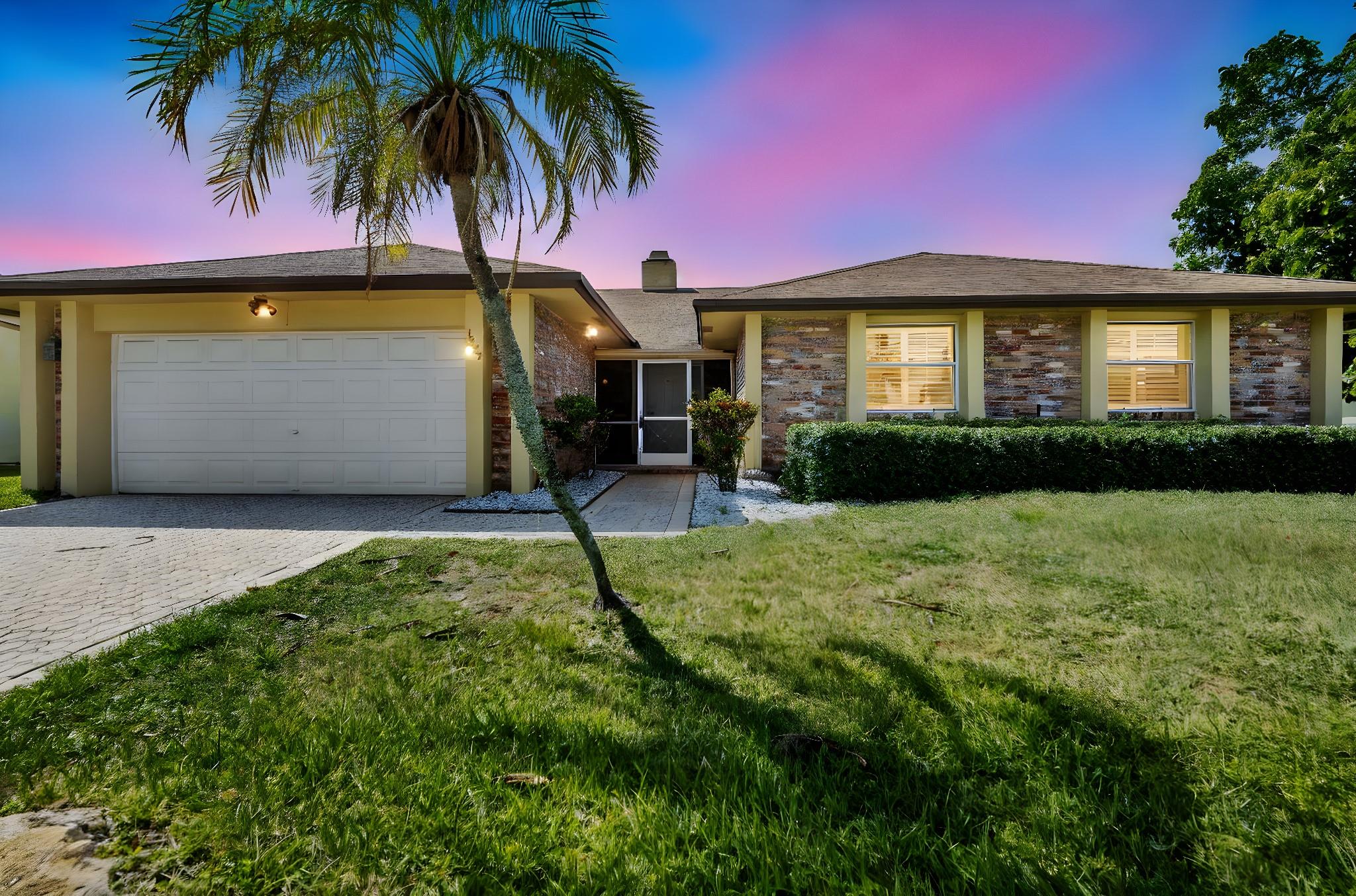 Welcome to this beautifully remodeled 3-bedroom, 2-bathroom modern pool home in the family-friendly Crystal Heights neighborhood. Offering 2,259 sq ft of open-concept living space, vaulted ceilings, custom plantation shutters, new A/C, stunning tile, and hardwood flooring throughout. This home features a designer kitchen with custom cabinetry, quartz countertops, and stainless steel appliances. A striking dual fireplace adds warmth and charm, seamlessly connecting the living and dining areas. The spacious master suite includes a large walk-in closet, while hurricane-impact windows and doors provide safety and energy efficiency. Enjoy outdoor living in the expansive screened-in patio with sparkling pool. highlights include Avocado tree a huge garage with extra storage and a prime location.