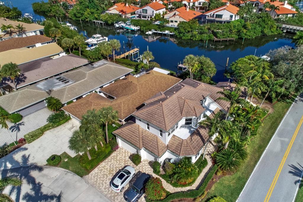 Totally renovated 3 bedroom, 5 bath home, new impact windows, new kitchen-cabinets and appliances , new lanai structure with it's own dock. New lighting installed throughout the house, new washer/dryer. Large office off the foyer with doors. This home is move in-ready, high ceilings, master suite on the first floor, master bedroom overlooking the water. There are 2 full suites each with their own baths, and 2nd floor landing has inviting coffee bar for the guests. This home is one of a kind!!.