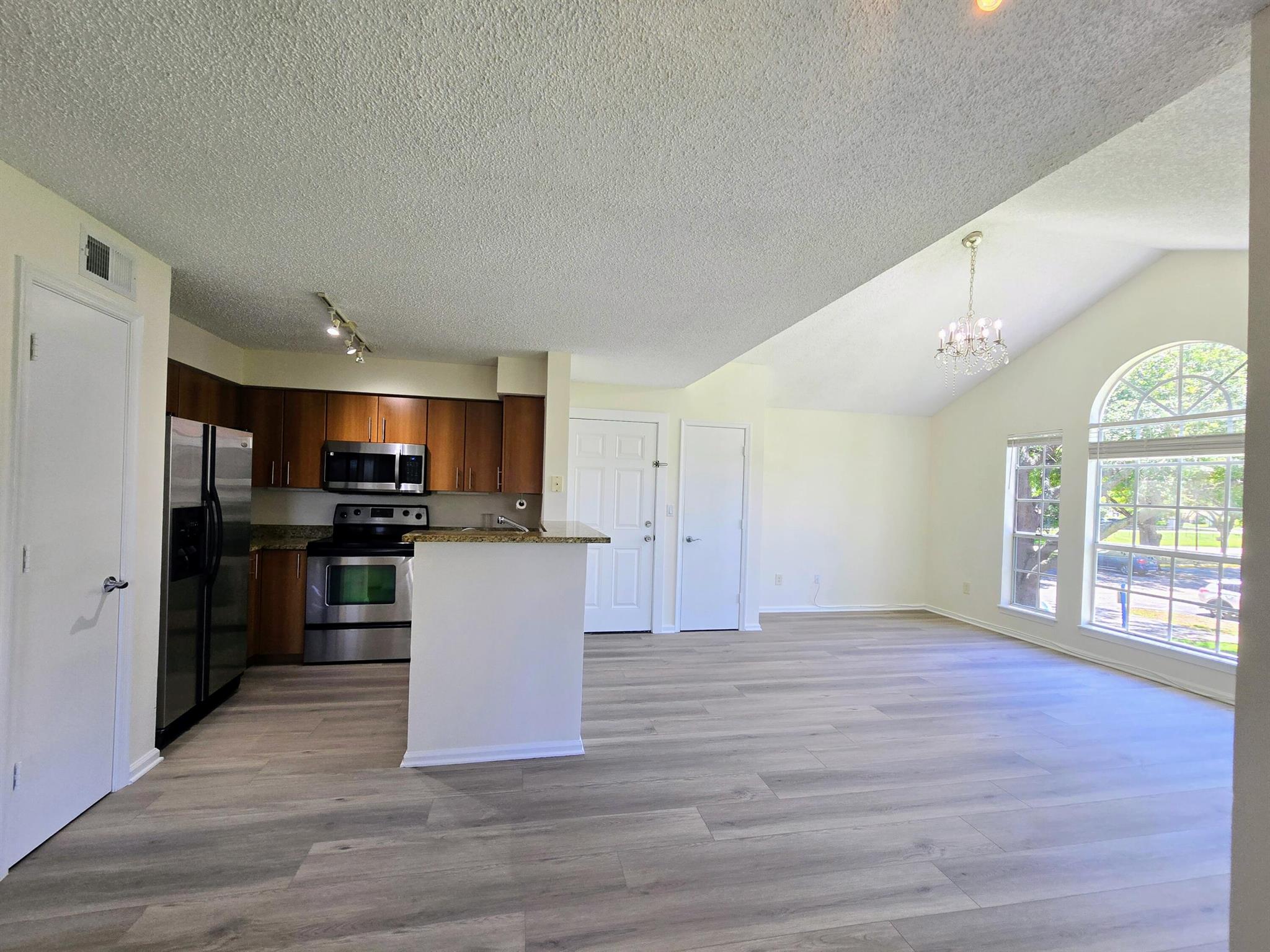This charming rental unit features 2 spacious bedrooms and 2 bathrooms, spread across approximately 948 square feet of living space. Step inside to find vaulted ceilings and a modern kitchen equipped with stainless steel appliances and granite countertops. Enjoy the convenience of a full-size washer and dryer, and take in the serene lake views from your private balcony or patio.