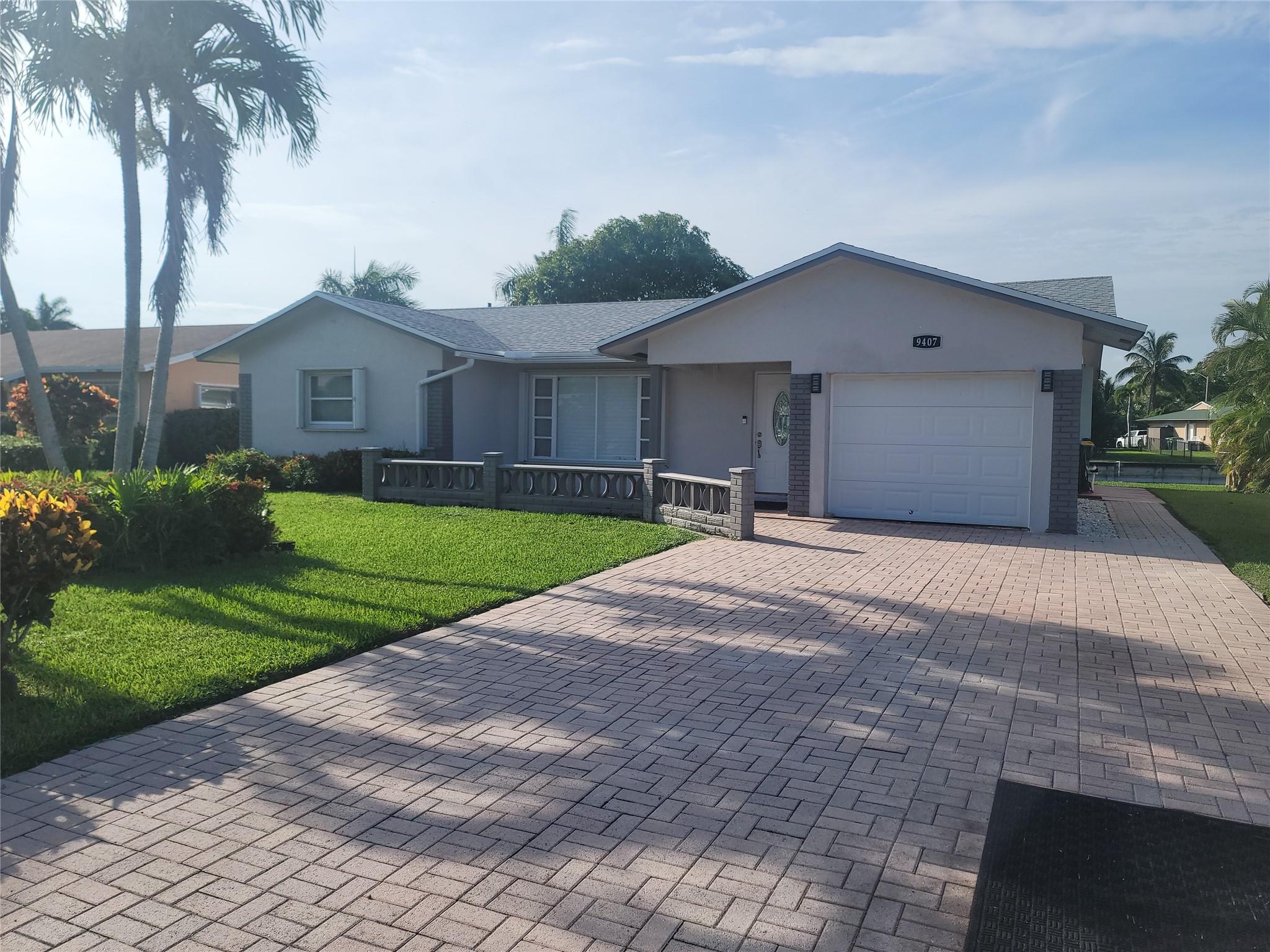 Breathtaking Water Views, Thoughtful Upgrades, Resort Style Living Waterfront Serenity in a Welcoming 55+ Community. have the peaceful, joy-filled lifestyle you’ve been waiting for. Perfectly nestled on a quiet waterfront lot in one of Tamarac’s most desirable 55+ communities, this charming, upgraded home offers spectacular serene sunset views. Ending each evening in your screened-in lanai with a gentle breeze as the sun paints the sky in golden hues. It’s a moment of peace you'll look forward to. Inside find a beautifully renovated kitchen and updated bathrooms, Office space, a spacious walk-in dressing room, 1-car garage, paved driveway and paths. Outside, enjoy lush Hibiscus Blooms & Hayden Mango Trees, as the lake glistens in the afternoon light giving you a feeling of tranquility.