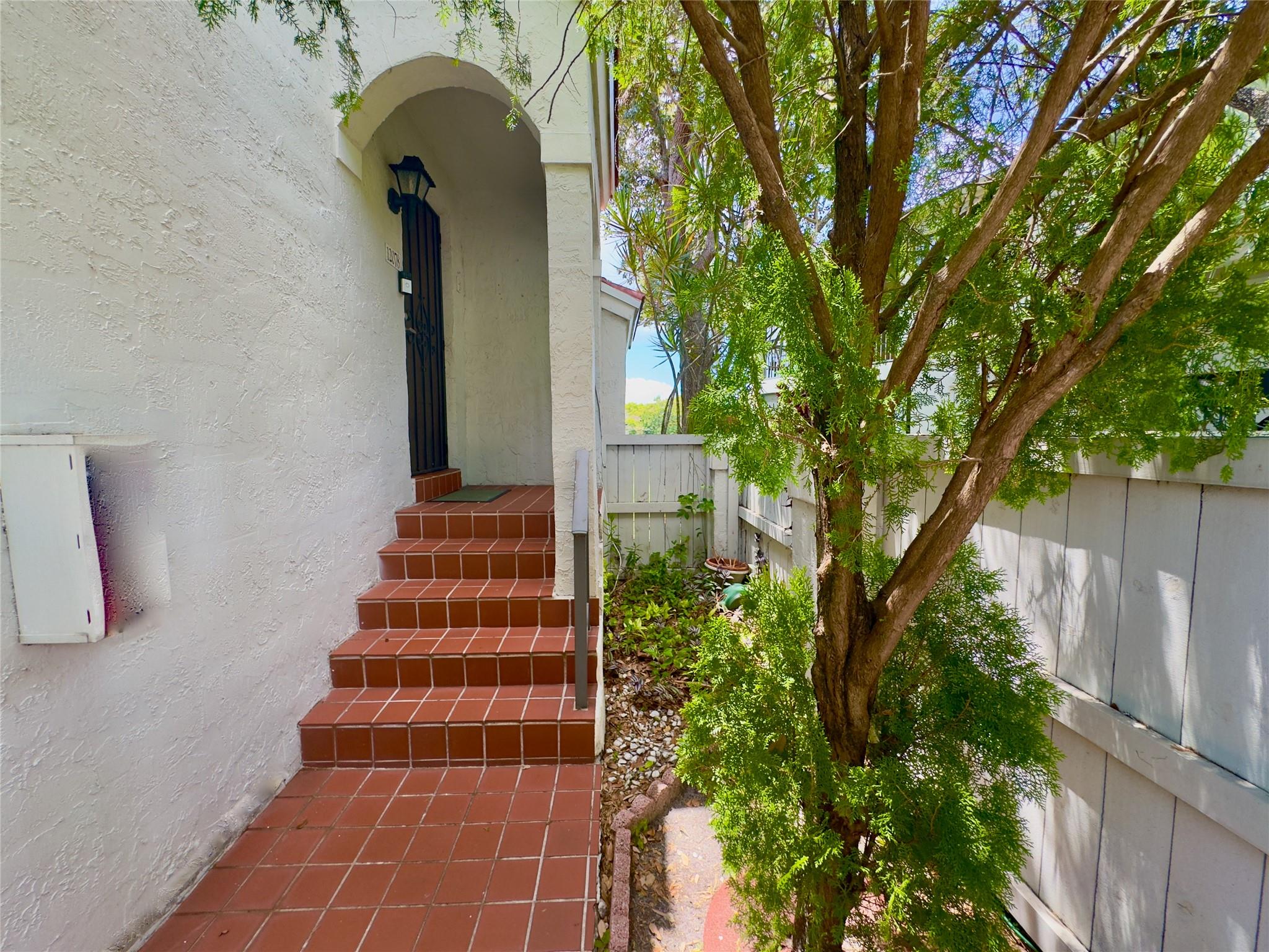 Check out this 3-bedroom, 2-bath corner unit overlooking the lake in the gated Pierpointe community with 24/7 security. You will love the split floor plan, beautiful wood floors, and plantation shutters throughout. The open kitchen features granite countertops and stainless steel appliances, perfect for cooking and hanging out. Step outside to a big patio with peaceful lake views — great for relaxing or entertaining. Extras include a tankless water heater, accordion shutters, and washer/dryer inside. The roof was replaced in 2024, and the community is getting a fresh new look with paint, PVC fences, and updated signage. Plus, it’s super convenient — close to hospitals, shopping, A-rated schools, and easy highway access.