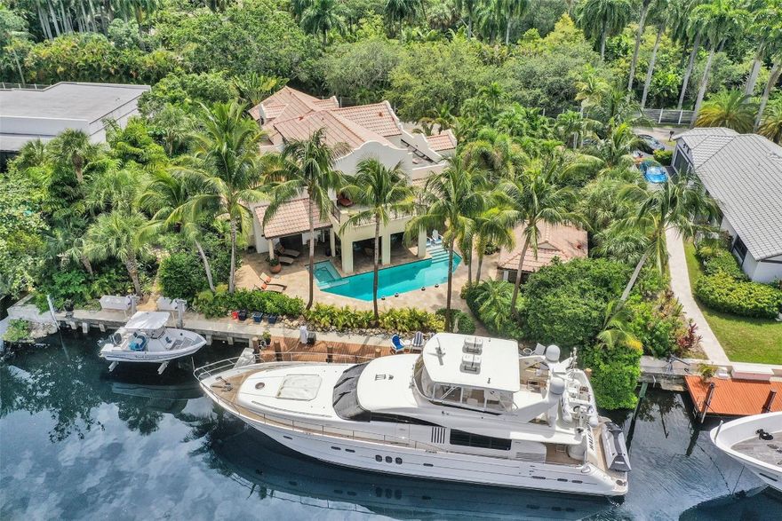 EXPERIENCE THE PINNACLE OF COASTAL LIVING IN THIS EXQUISITE CUSTOM ESTATE, BOASTING 122 FEET OF PROTECTED DEEP-WATER FRONTAGE ON A WIDE CANAL WITH NO FIXED BRIDGES. PERFECTLY ENGINEERED FOR THE YACHTING ENTHUSIAST, THIS PRIME LOCATION EASILY ACCOMMODATES A 100-FOOT VESSEL.  BUILT IN 2007 WITH UNCOMPROMISING QUALITY, THE INTERIOR FEATURES EXOTIC WOODS, RARE STONES, & HIGH-END FINISHES. THE LAYOUT OFFERS THREE EXPANSIVE ENSUITE QUARTERS, EACH FEATURING PRIVATE SITTING AREAS FOR ULTIMATE SECLUSION. AT THE HEART OF THE HOME, A GOURMET KITCHEN WITH DOUBLE ISLANDS & PROFESSIONAL APPLIANCES AWAITS THE CHEF.  STEP OUTSIDE TO A PRIVATE RESORT: A HEATED POOL, LUSH TROPICAL GROUNDS AND A SUMMER KITCHEN WITH A COVERED LANAI. COMPLETE WITH A WHOLE-HOME GENERATOR AND OVERSIZED GARAGE.  TRULY A MUST SEE!