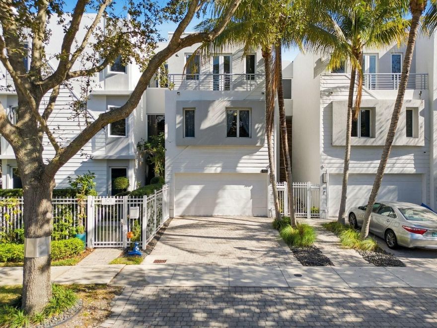 Live the Victoria Park lifestyle in this sophisticated 3-story townhome with private elevator. Located in a modern boutique enclave just moments from Las Olas, downtown Fort Lauderdale, Holiday Park, and the beach. This residence features impact windows, soaring ceilings, travertine floors, and a 2-car garage. Three en-suite bedrooms, walk-in closets, with two opening to private balconies. A dramatic multi-story atrium floods the home with natural light. The top level includes a second living area, dedicated office space, and an expansive private rooftop deck ideal for entertaining or relaxing. A fenced patio enhances indoor-outdoor living. Meticulously maintained, secure, and move-in ready in one of Fort Lauderdale’s most walkable neighborhoods.