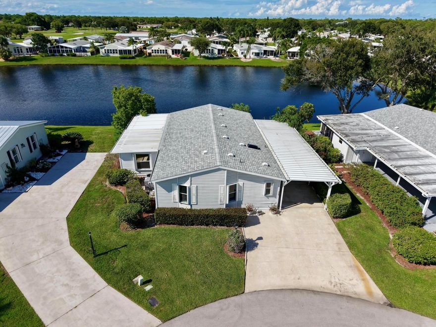 Don't miss the chance to make this lovely 2001 double-wide modular home your very own! Priced to sell, this home offers tremendous value and just needs a bit of TLC to truly shine.  Enjoy stunning lakefront views in the Preserve at Savanna Club, a lively 55+ golf community. This 2-bed, 2-bath home features an open floor plan, Florida room for hobbies or office, new AC, and is set on a quiet cul-de-sac with a spacious carport and storage. Extras include hurricane shutters. Resort amenities: 18-hole golf course, fitness center, clubhouses, and year-round activities. Close to beaches, shopping, and dining. Lot rent is $765 a month.