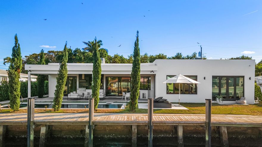 WELCOME HOME TO YOUR TURN KEY, NEW CONSTRUCTION WATERFRONT MASTERPIECE. This bright, contemporary 3 BR, 2.5BA home boasts 90 FT of waterfrontage, a 20,000 LB brand new boat lift and sea wall, an open gourmet kitchen meticulously designed by NEFF LIVING, natural marble stone throughout the kitchen and all bathrooms, beautiful infinity edge heated salt water pool, full outdoor kitchen, entire home generator, security camera system, his and her master closets and much more.