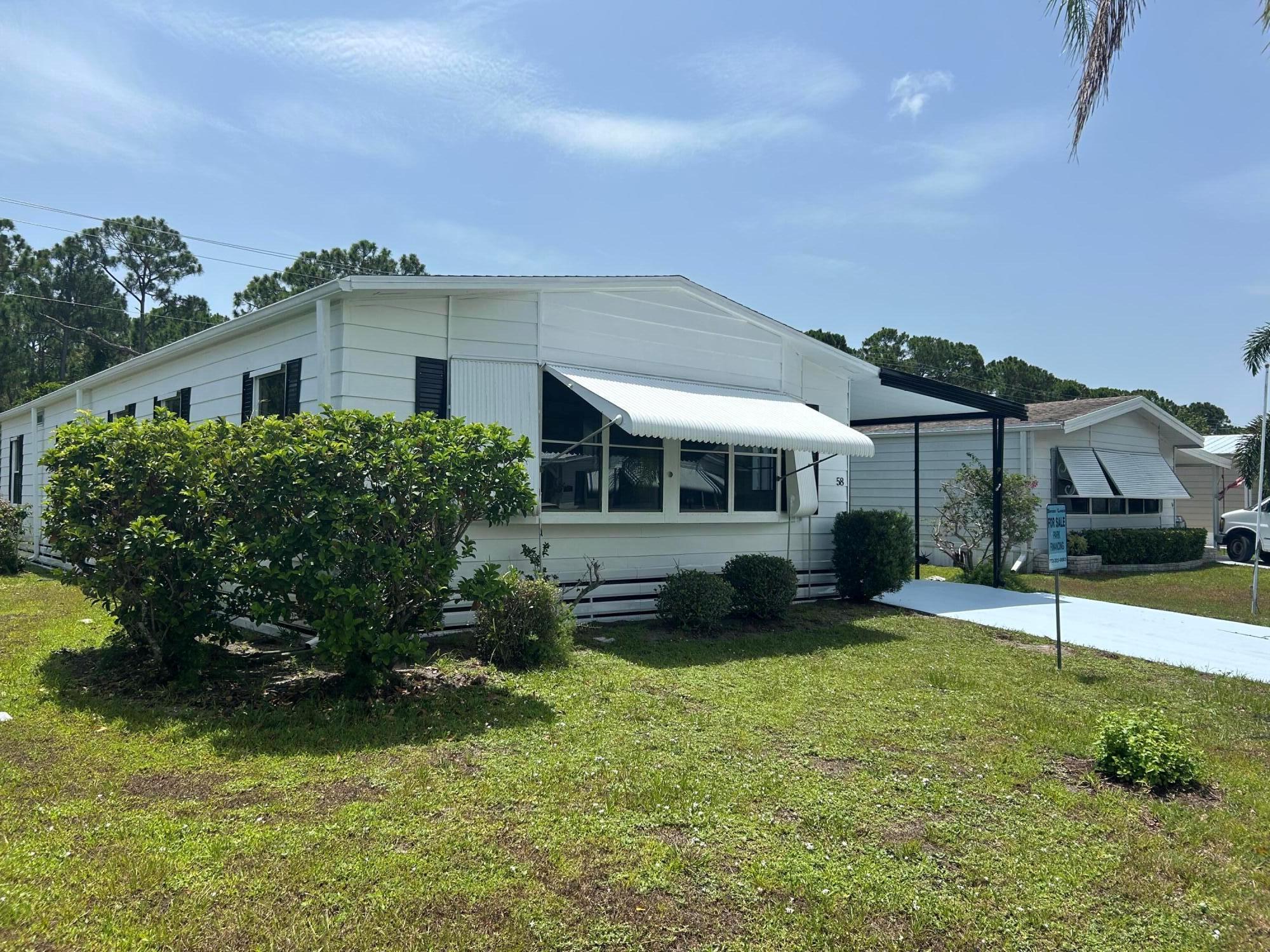 Bright & Beautiful Move-In Ready Home in Spanish Lakes! This home comes with a $699 Lot Rent and Brand New Kitchen Appliances which will be installed prior to closing!Welcome to 58 Calle de Lagos, a beautifully maintained home located in the desirable Spanish Lakes Country Club. This move-in ready gem offers the perfect blend of comfort, convenience, and affordability -- making it an ideal Florida retreat or year-round residence.Step inside to discover a spacious layout flooded with natural light, creating a warm and inviting atmosphere throughout. One of the true highlights of this home is the oversized Florida room. The home comes fully equipped with all appliances, including a washer and dryer, so you can settle in with ease.