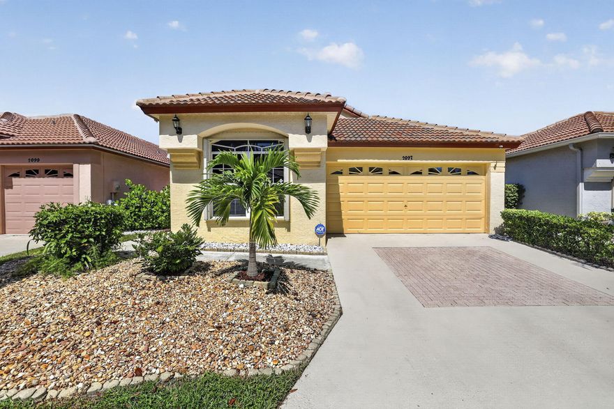 Beautifully updated lakefront single-family home located in the highly desirable gated community of Woodbine. Situated on a premium lot with expansive long lake views, this move-in-ready 2BR/2BA home with a 2-car garage offers stylish upgrades, vaulted ceilings, and an open, light-filled floor plan. Interior features include plantation shutters, a screened entry, updated flooring, and spacious living areas designed for comfortable everyday living and entertaining. The kitchen was remodeled in 2025 with modern cabinetry, quartz countertops and backsplash, stainless steel under-mount sink, and stainless steel appliances, with select appliances replaced in 2025 including the oven. The space is completed by a French-door refrigerator with water and ice dispenser.  Additional recent upgrades include new laminate flooring in the kitchen and baths (2025) and new washer and dryer (2025). The primary suite offers serene water views, custom closets installed in 2024, and an updated en-suite bathroom featuring a renovated walk-in shower completed in 2025/2026 with frameless glass enclosure, pebble accent flooring, handheld shower wand, updated vanity with quartz countertop, and modern fixtures. The soaking tub remains original. The guest bathroom was updated in 2024 with a new vanity, quartz countertop, framed mirror, and modern hardware. Plush bedroom carpeting was replaced in 2025 for added warmth and comfort. Enjoy relaxing lake and fountain views from the spacious screened lanai with custom shades, ideal for indoor-outdoor living. The finished 2-car garage was upgraded in 2024 with epoxy flooring, built-in shelving, and a slat-wall storage system for added organization and functionality. Major system improvements provide peace of mind and include a new tile roof (2022), plumbing replacement (2026), accordion hurricane shutters, and ADT security system with exterior cameras. Woodbine offers 24-hour manned gated security and resort-style amenities including 2 community pools, clubhouse with fitness center, tennis, pickleball, racquetball, volleyball, playground, sports field, shuffleboard, and sidewalks throughout the community. HOA includes cable and internet. Boat and RV storage may be available through the HOA for an additional fee, subject to availability and HOA approval. Conveniently located near shopping, dining, golf, beaches, and major highways. Welcome Home!