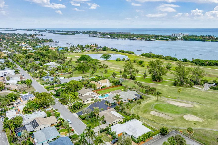 This immaculately maintained Midcentury home is nestled along the northern end of the golf course in Eden Place. Meet the day with a cup of coffee in hand watching the sunrise over the Intracoastal and golf course. This solid CBS constructed home is 2 bedrooms, 2 baths, the primary bedroom featuring an en suite bath, and two living areas, plus a large 11 by 9 dedicated laundry room with abundant pantry storage, and an attached 2-car garage. Every room looks onto the golf course through large picture windows. There is expansive outdoor space. The 32 foot by 12 foot patio deck overlooking the course has a retractable awning, making this a beautiful outdoor room to enjoy in any weather. Don't miss this opportunity to own a piece of paradise! Hip and artsy downtown Lake Worth Beach