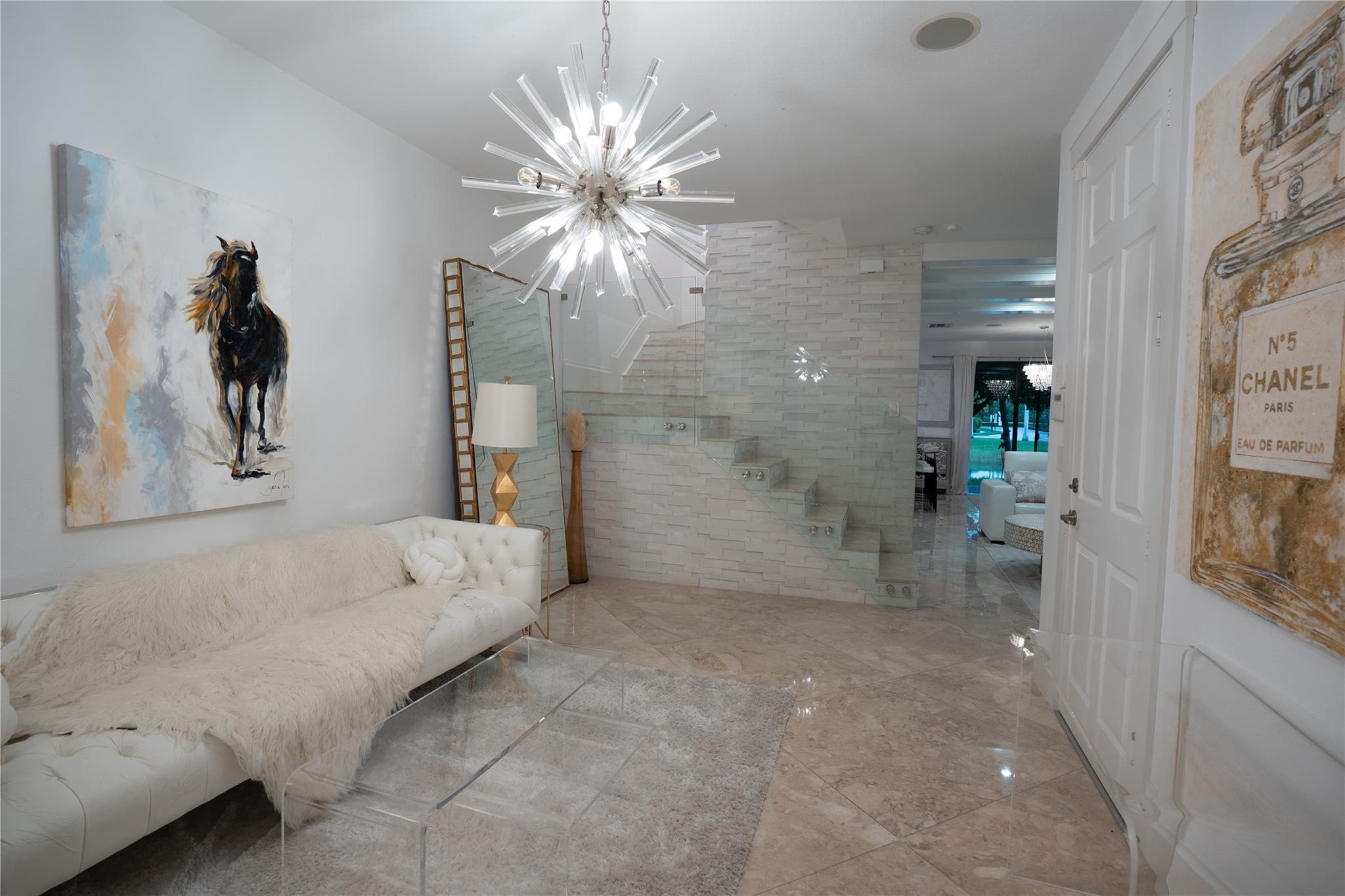 Stunning Cedar model 3BD/2.5BA waterfront townhome in Ashton Parc! Features include marble floors throughout, custom accent walls, glass staircase with tile backdrop & upgraded designer lighting. The newly renovated kitchen showcases two-tone white & wood cabinetry, gold faucet, double oven & flat-top stove. Dining area shines with chandelier, accent wall, opening to a patio with serene water views. Upstairs, the primary suite offers tray ceiling, custom California closet, dual sinks & walk-in shower. Includes 1-car garage. Community amenities: pool, nightly security, beautiful landscaping. Prime location near shopping, dining, schools, The Promenade, Turnpike & Sawgrass.