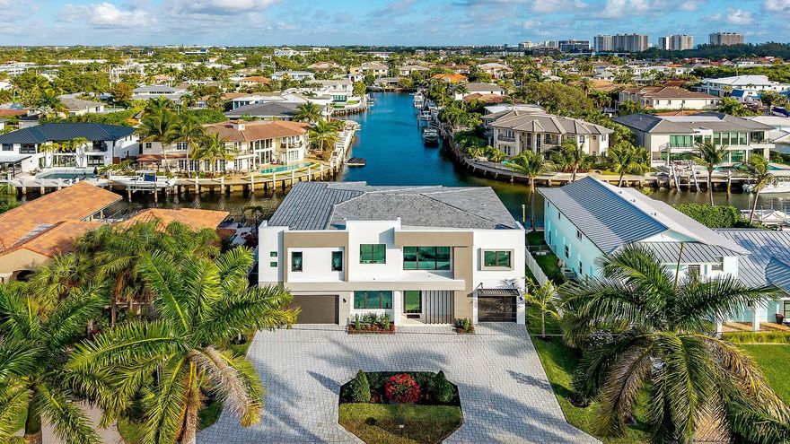 Crafted by Charles Thomas Builders, this brand new waterfront residence is a rare offering in Blue Inlet, one of East Boca Raton's most coveted enclaves. Moments from the beach, Intracoastal and ocean access, Mizner Park, and Atlantic Avenue in downtown Delray Beach. Set on 80' of waterfrontage with long water views and a wide canal for easy boat maneuvering. Features include a 3 car garage, custom kitchen with Thermador appliances and wet bar, floor to ceiling glass sliders, covered loggia with summer kitchen, ground floor VIP guest suite and office. Upstairs, the primary wing enjoys a waterfront balcony, dual walk in closets, and custom bath, accompanied by 3 additional guest suites, loft and laundry room. Boasting poured concrete construction on pilings, this home is ready for season! Crafted by Charles Thomas Builders, this brand new waterfront residence presents a rare offering in Blue Inlet, one of East Boca Raton's most coveted coastal enclaves. Ideally positioned just moments from the beach and the Boca Inlet, with direct Intracoastal access just seconds from the private dock, and a short drive to Mizner Park and Atlantic Avenue in downtown Delray Beach, the location delivers the very best of South Florida coastal living.

Set along 80 feet of prime waterfront frontage, the home enjoys extraordinary long water views and a uniquely wide canal that allows easy boat maneuvering and turnaround. Designed for refined living and entertaining, the residence features a three car garage, a custom chef's kitchen with a premium Thermador appliance suite, and floor to ceiling glass sliders that frame the water from nearly every main living space. A covered loggia with summer kitchen creates a seamless connection between indoor elegance and outdoor leisure.

The ground floor offers a private VIP guest suite and a dedicated office. Upstairs, the expansive primary wing captures captivating water views, a private waterfront balcony, dual walk in closets, and a spa inspired bath. Three additional guest suites and a loft complete the upper level. A custom residential elevator connects both floors with ease and convenience.

Built with poured concrete construction and set on pilings, this residence reflects exceptional craftsmanship, structural integrity, and enduring quality. Brand new, thoughtfully executed, and perfectly positioned on the water, this is a rare opportunity to own a truly exceptional coastal estate ready to be enjoyed immediately.